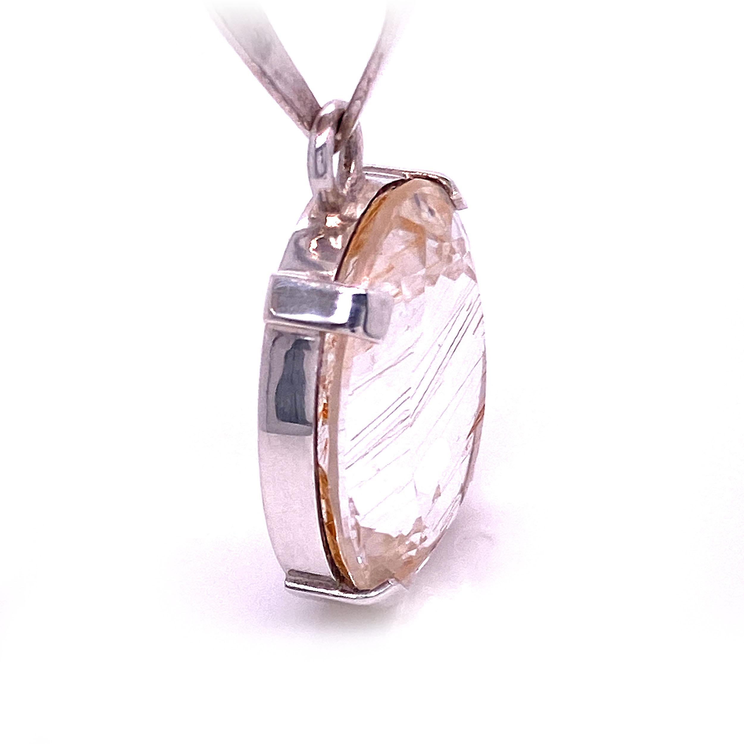 This Gemjunky pendant is a sparkly oval faceted Brazilian Quartz with striking lines of Rutile running through it. This bright oval is a generous 21 x 18 mm.  The one of a kind  pendant is a total of 37 mm in length. It was created in our studio in