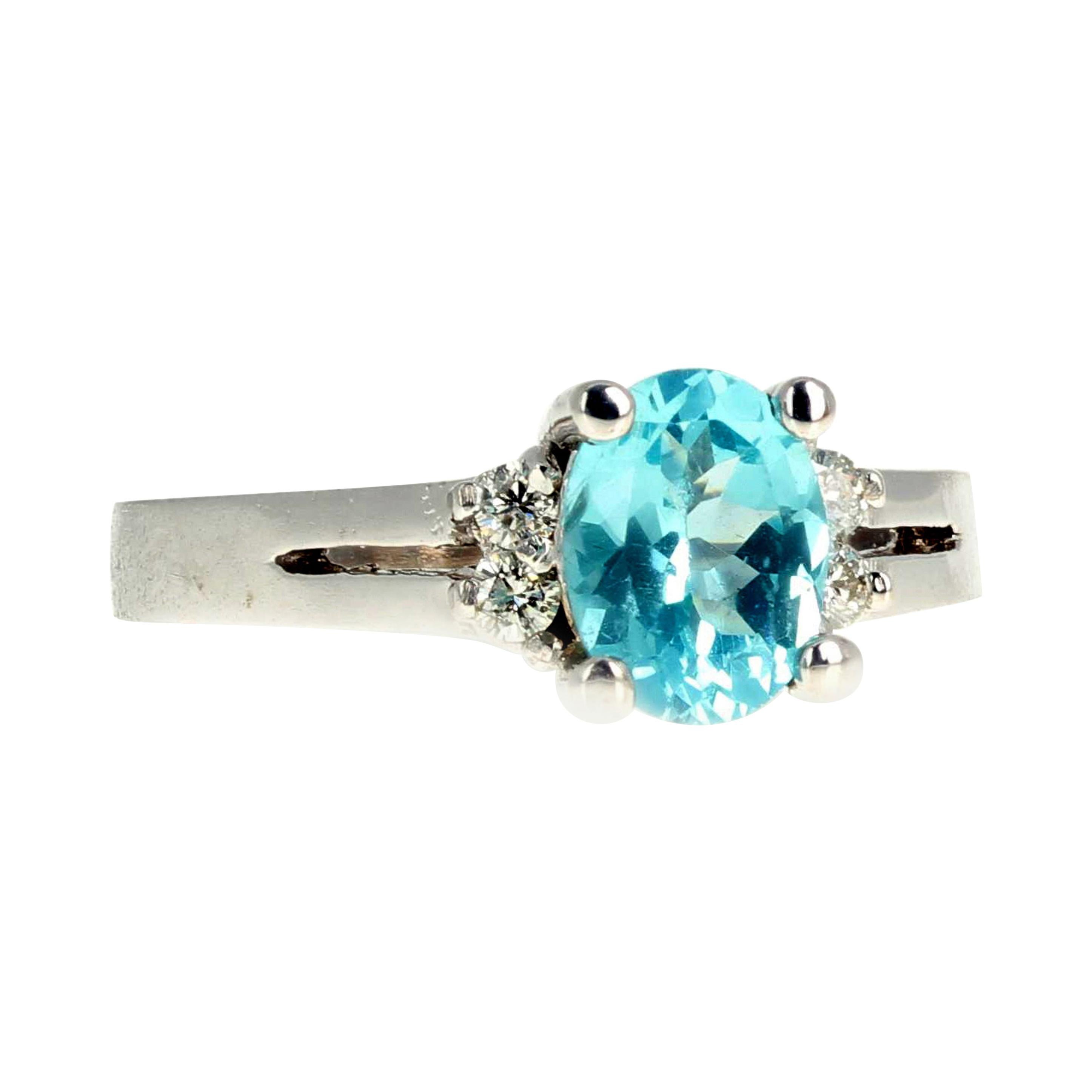 This beautiful brilliantly bright natural blue 1.26 carat Apatite (8 mm x 6 mm) is enhanced with 0.15 carats of natural glittering white Diamonds set in this 14K white gold ring size 7 (sizable for free).  