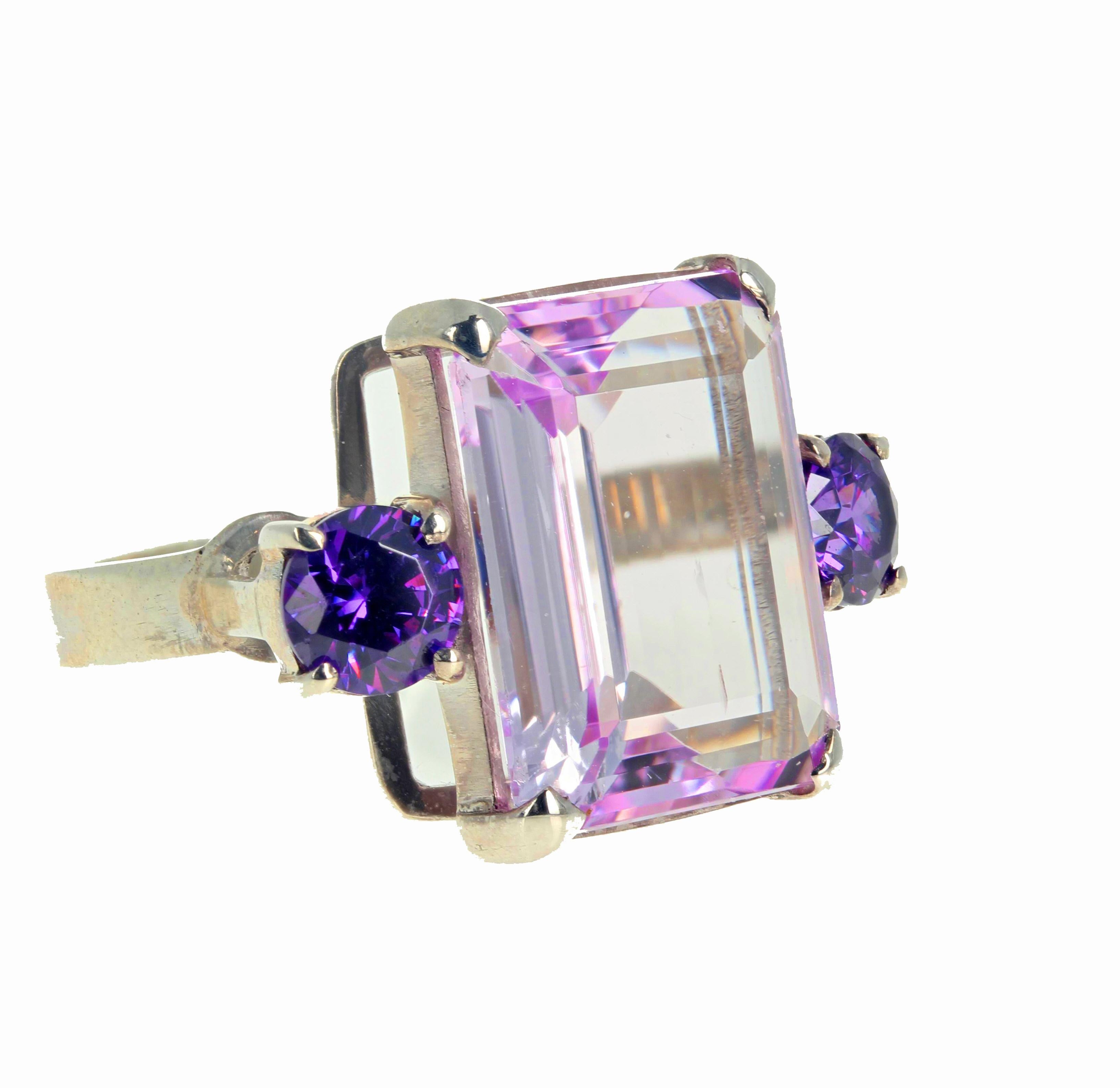 The clarity and beauty of this beautiful pinky translucent Kunzite (13.7 carats) is in its magnificent large size - 17.7 mm x 13.3mm - and in its enhancement by the glittering bright natural Amethysts (.70 carats each).  This ring is a size 8