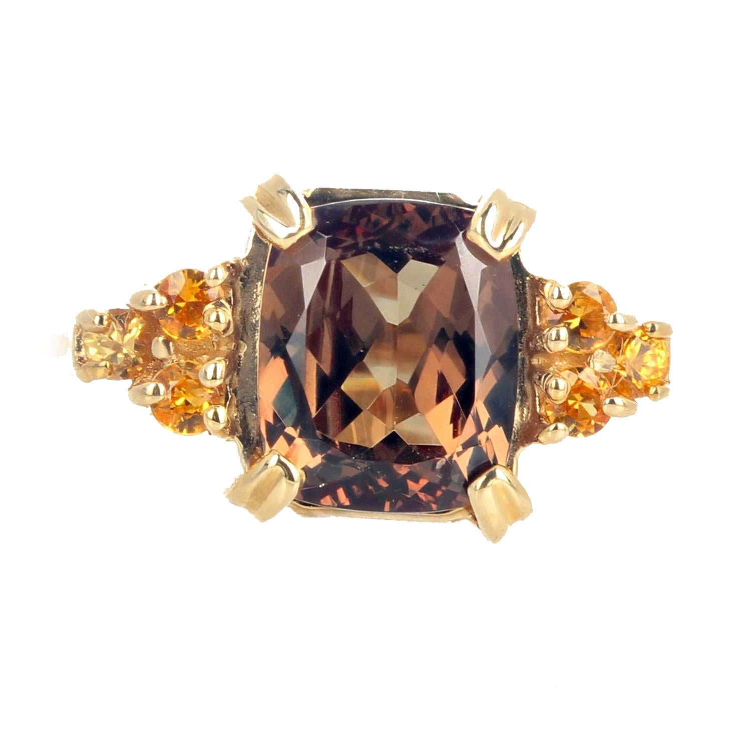 This very rare fiery unique natural color change 2.62 carat Garnet is flanked by 6 intense yellow natural 2.2 carats of Sri Lankan Sapphires.  This classic 14Kt yellow gold ring size 7 (sizable) is the perfect gift to honor someone on their special