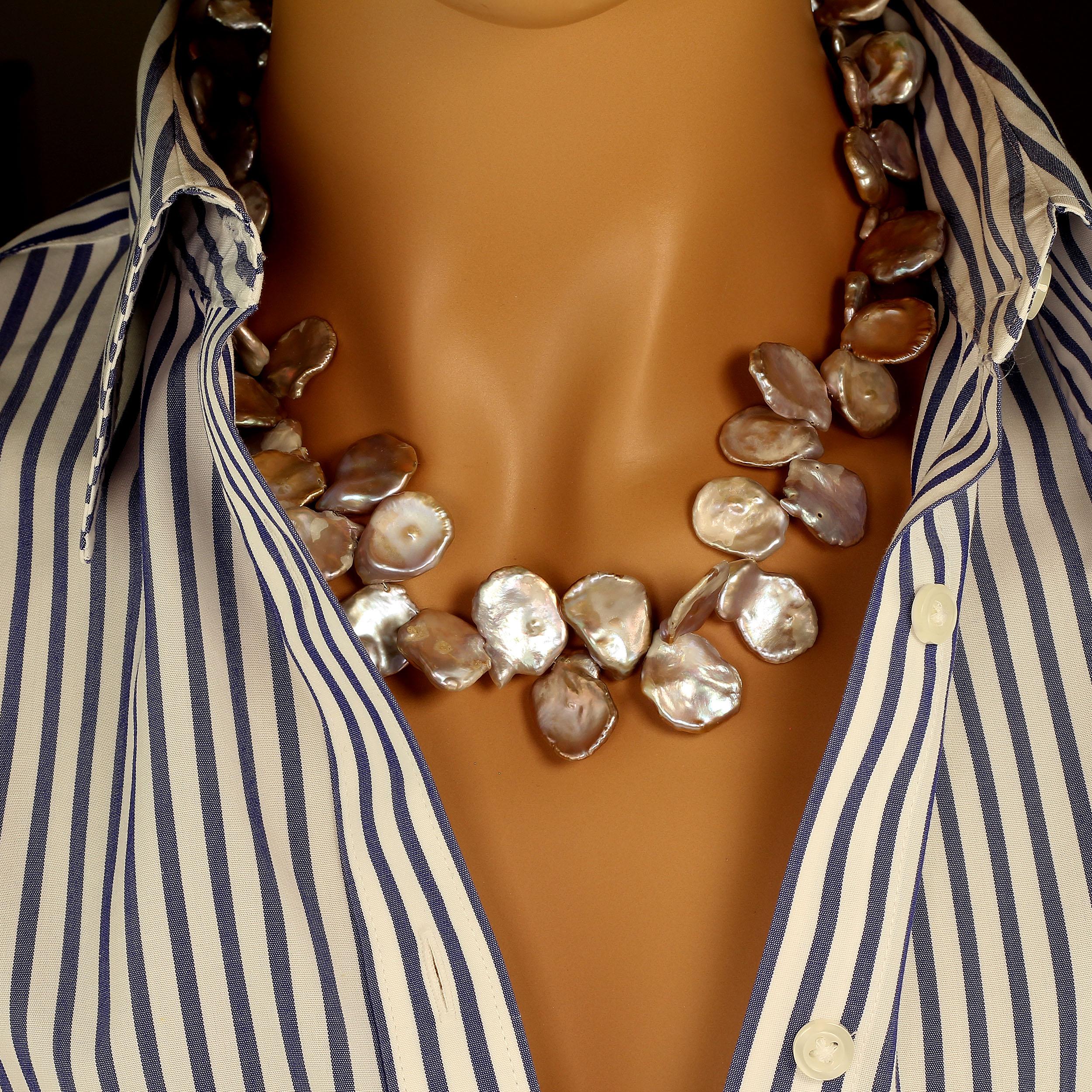Keep Calm and Wear Pearls

Graduated gray iridescent Keshi Pearl necklace. These lovely Pearls flash shades of pink and blue through their uneven nacre. The pearls are flat, and more or less round ranging from 15 to 20 MM in diameter. This necklace