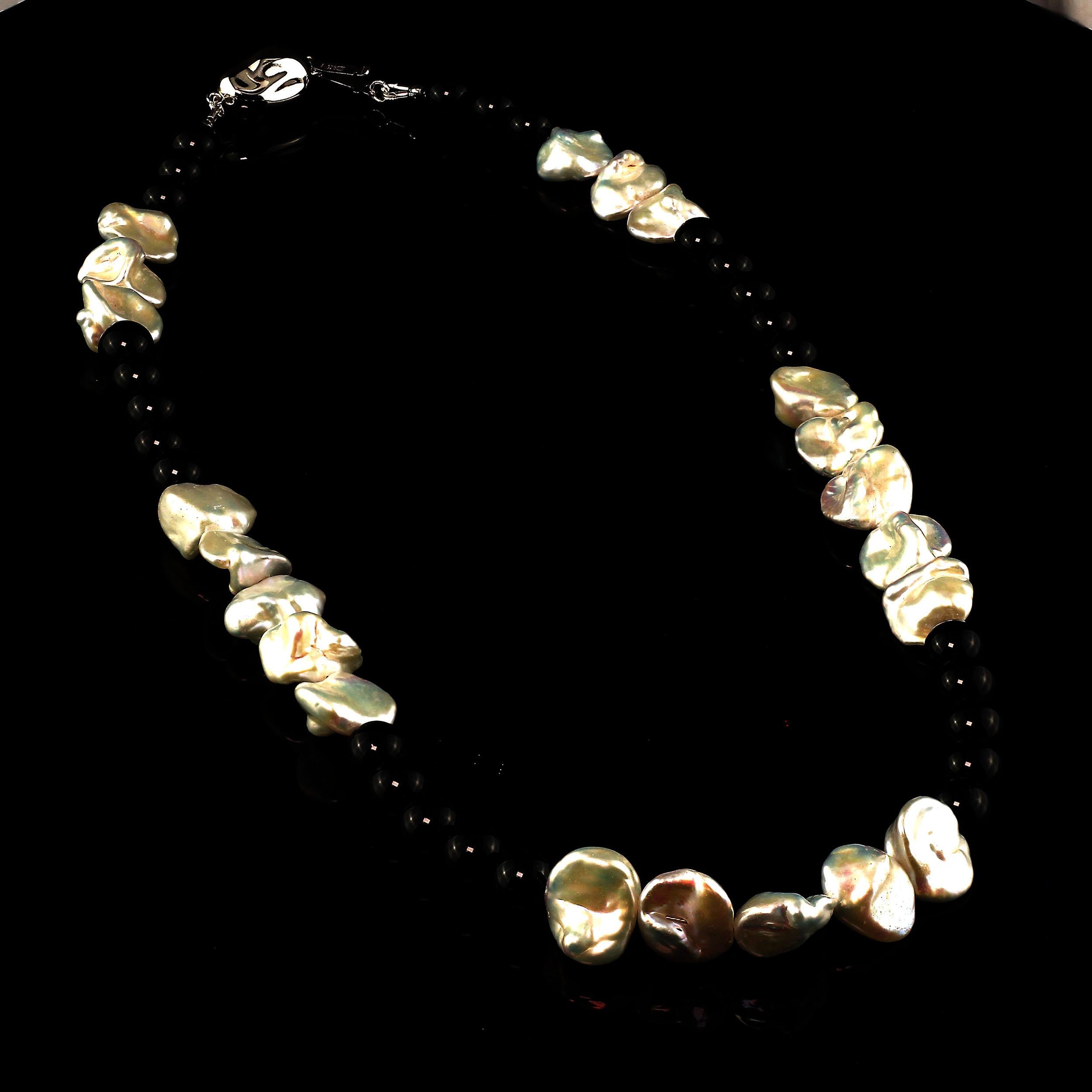 Gemjunky, unique black and white necklace.  This gorgeous necklace is a combination luscious, iridescent keshi Pearls (up to 13 MM) and smooth 8 MM Black Onyx.  The elegant style of this necklace will carry it from morning through the day and on