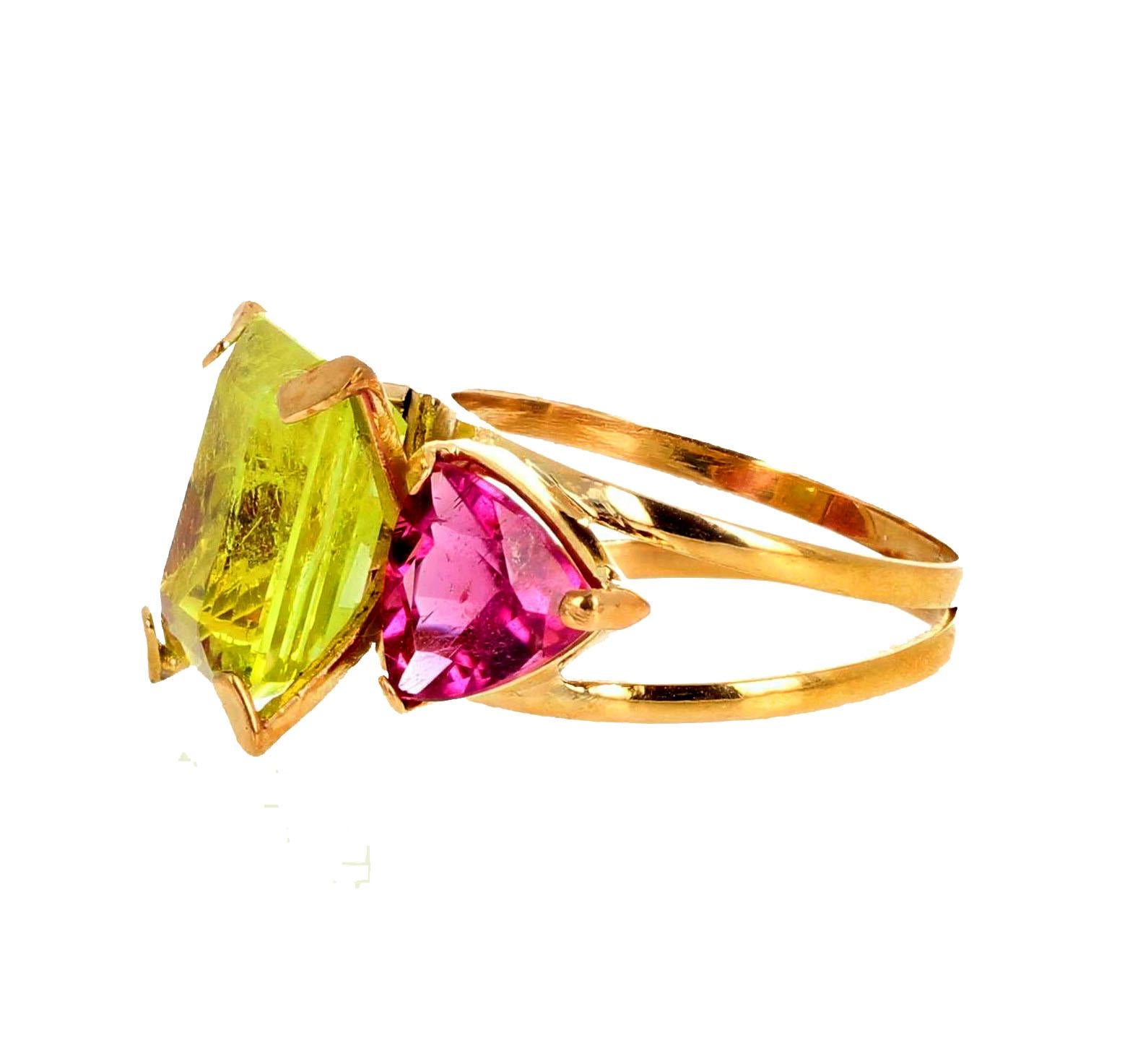 Magnificent glittering yellow green natural 5.17 Carat Chrysoberyl enhanced with two trillion 1.7 carats each gem cut natural bright pink Tourmalines set in 18K yellow gold ring size 7 (sizable). This magnificent Chrysoberyl is found in Brazil, Sri