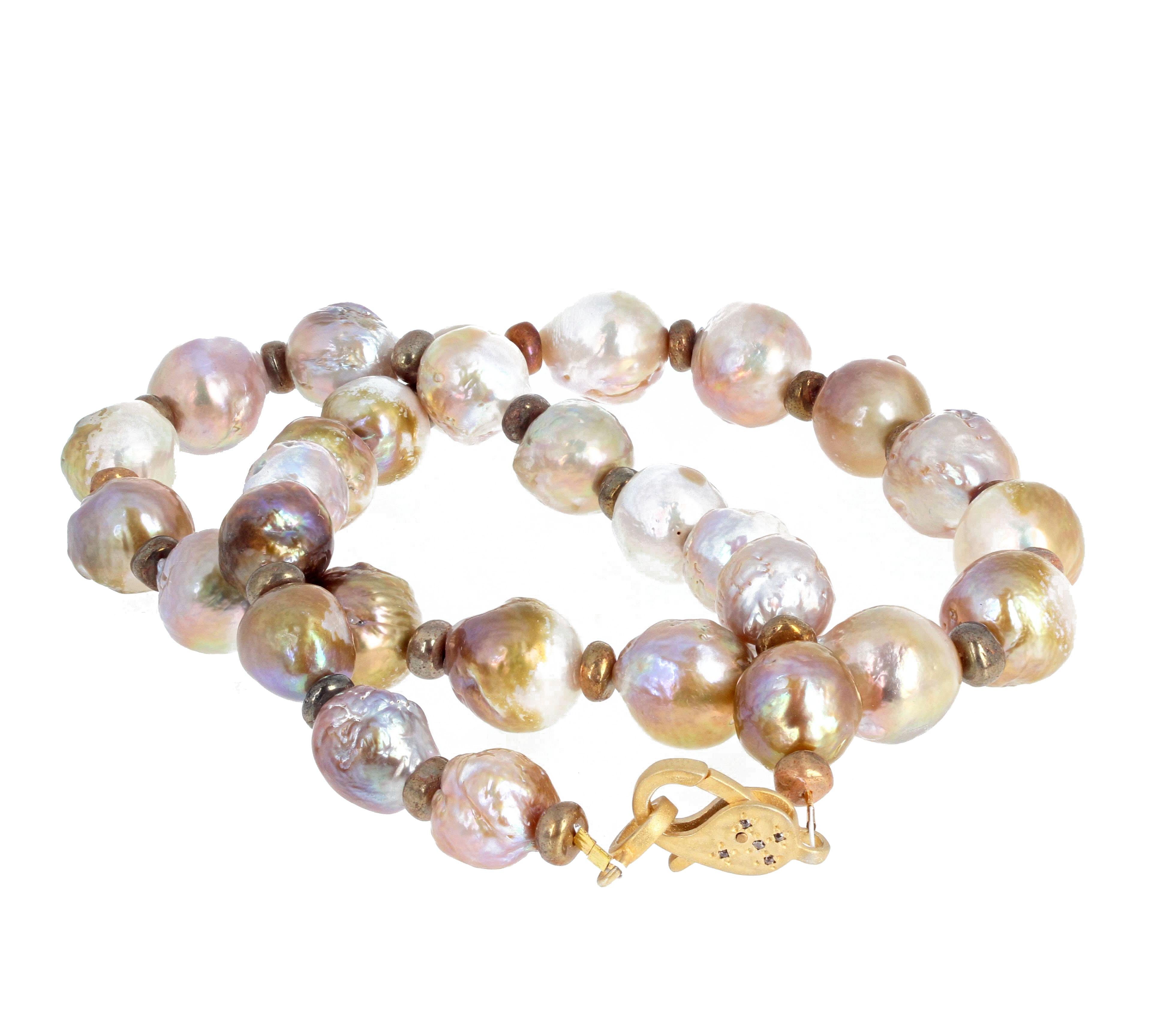 This is fascinating and extremely beautiful as these ocean cultured Pearls glow magnificently around your neck.  They go from the largest at 15.7mm to the smaller ones on the end at approximately 13.5mm round.  They are enhanced with teeny round