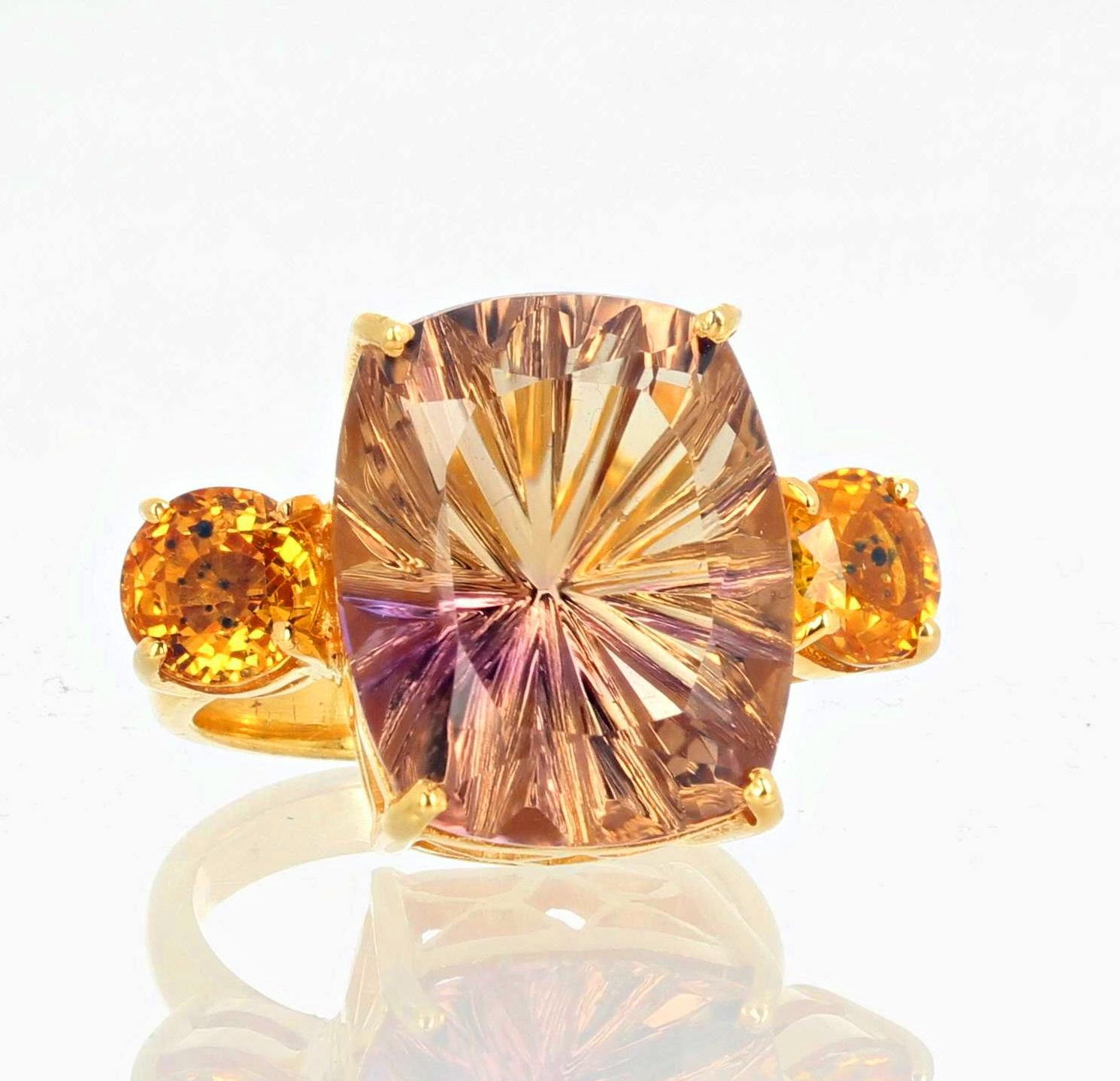 This magnificent fiery 12.02 carat blush gold multi-color natural Citrine (17.3 mm x 14.3 mm) flanked with 2.66 carats of fiery gold natural Songea Sapphires.  This classic setting is gold plated sterling silver size 7 sizable. The cut is a Fantasy
