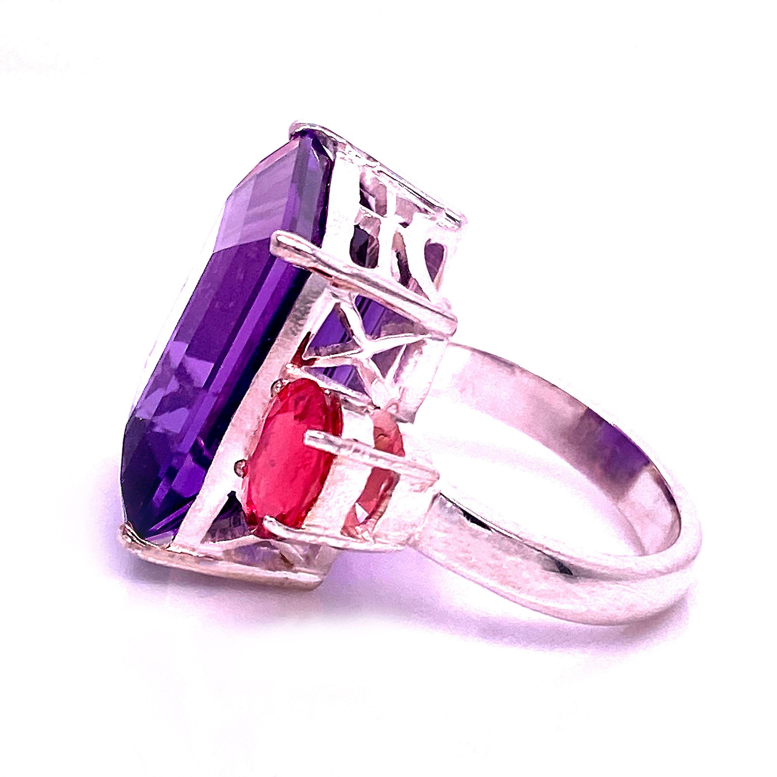 Life of the Party Pink and Purple Ring!  Sparkling emerald cut Amethyst accented with side stones of hot pink Tourmaline.  Wear this show stopper out to dinner, be prepared to accept the compliments as you tip that champagne glass to your lips! This