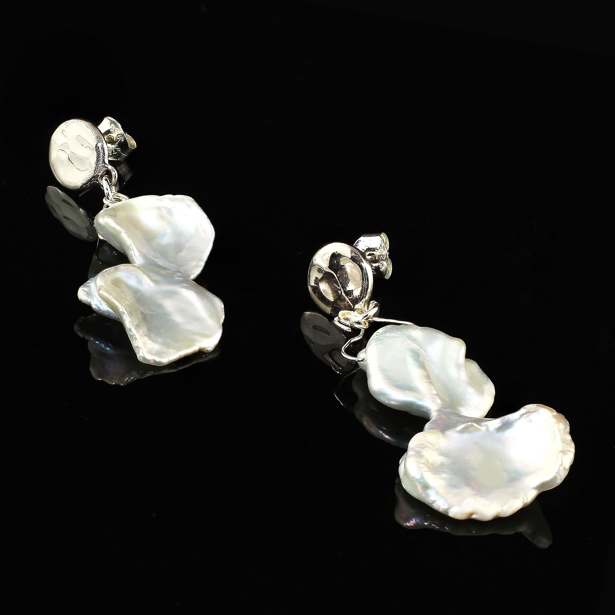 Unique Iridescent White Pearl earrings that swing from Sterling Silver posts.  These hour glass shaped freshwater pearls are approximately one inch in length and half that in width.  The pearl swings from silver wire attached to a highly polished