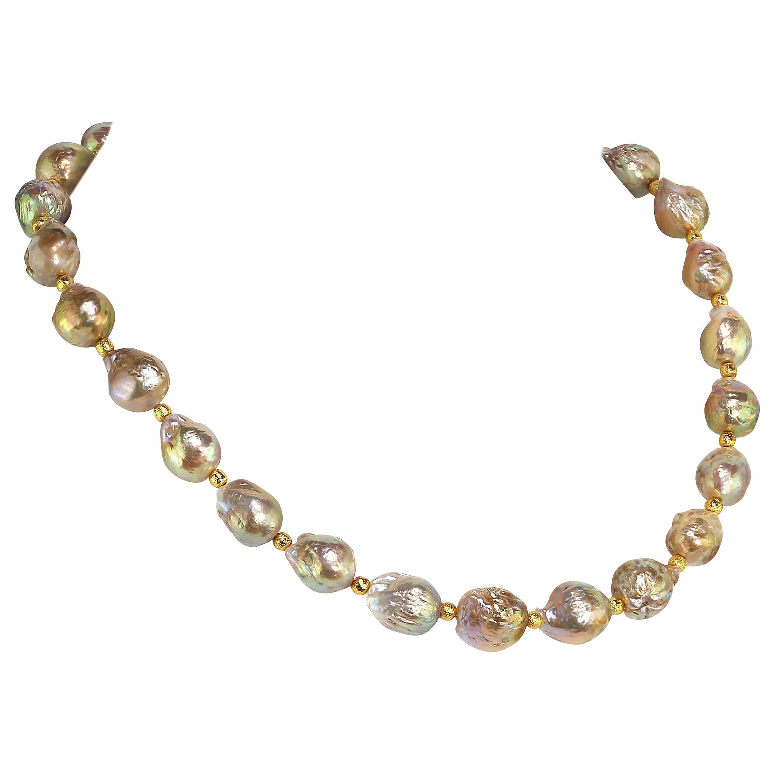 Own the pearls you desire

Iridescent Golden Baroque Pearl necklace that will be your 'go to' necklace from the moment you get it home. The pearls in this unique necklace flash pink, yellow, and green. At 18 inches this one of a kind necklace sits