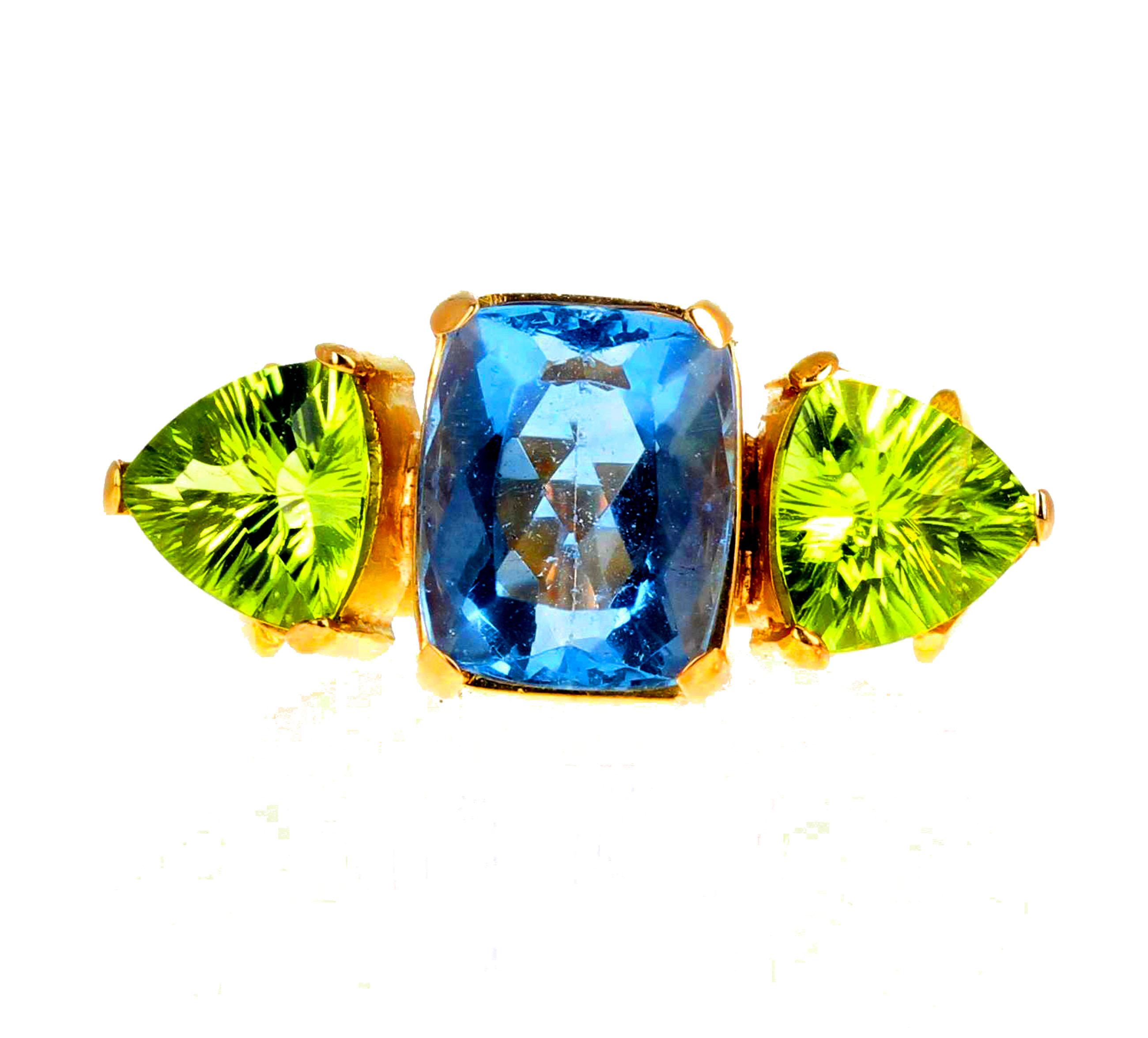 This is truly a magic ring as it plays tricks with the color change based on the lighting.  The color can go from blue to pinky blue in this clear 5 carat Fluorite (12mm x 9 mm). The natural Peridot are approximately 2.4 carats each (9 mm x 9 mm). 