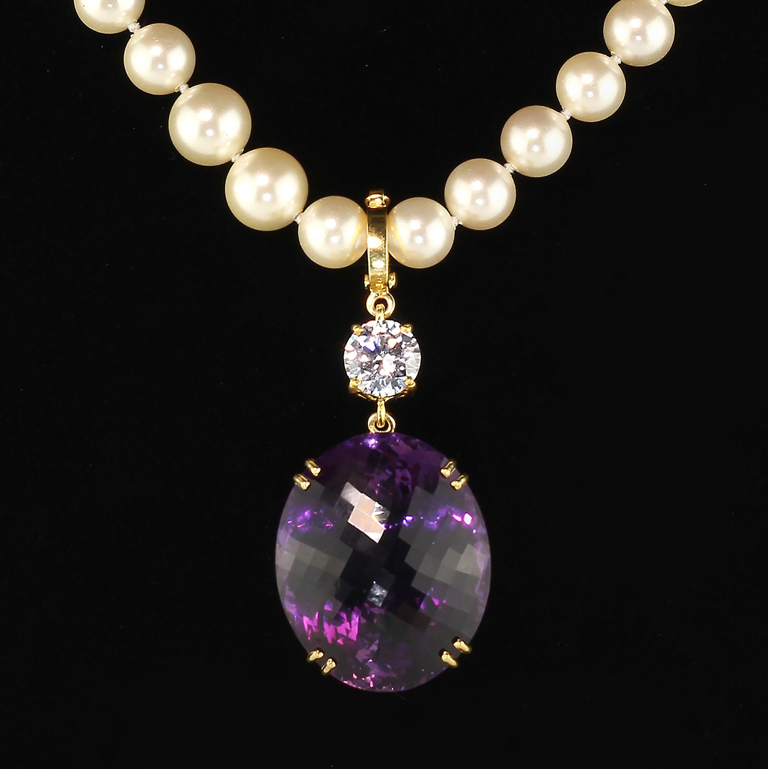 This incredible large Amethyst pendant sparkles and flashes as it moves. The 67.58 carat checkerboard table Amethyst is accented with a white genuine Zircon of 3.96 carats. Both gemstones sit in handmade woven baskets of gold rhodium plated Sterling