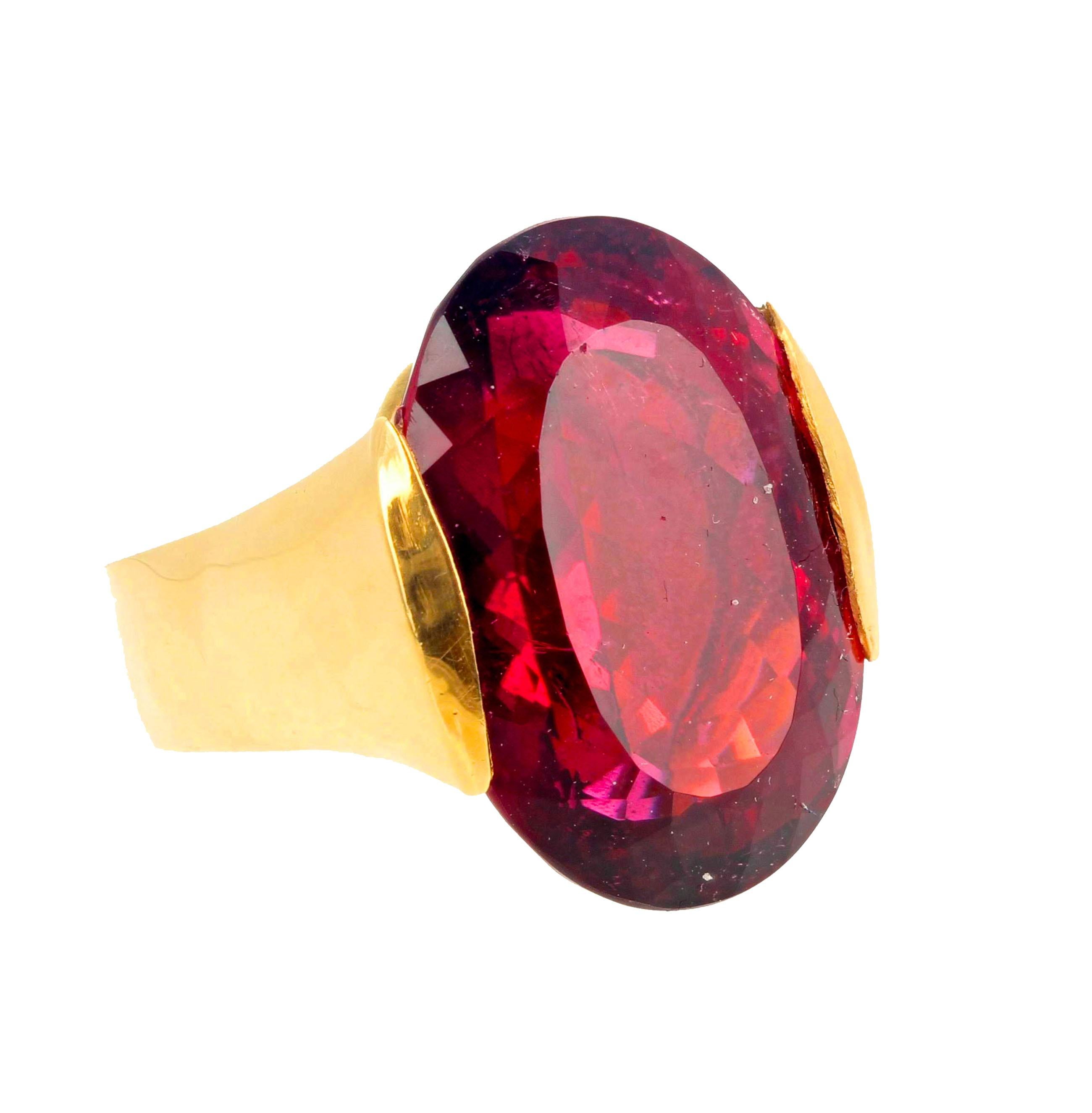 This solitaire gemstone is large enough to see from the moon.  This deep bright glowing natural Red Rubelite Tourmaline is set in this sizable 18KT yellow gold ring size 5 (sizable for free).  This is not a ring for the shy, it makes a surprisingly