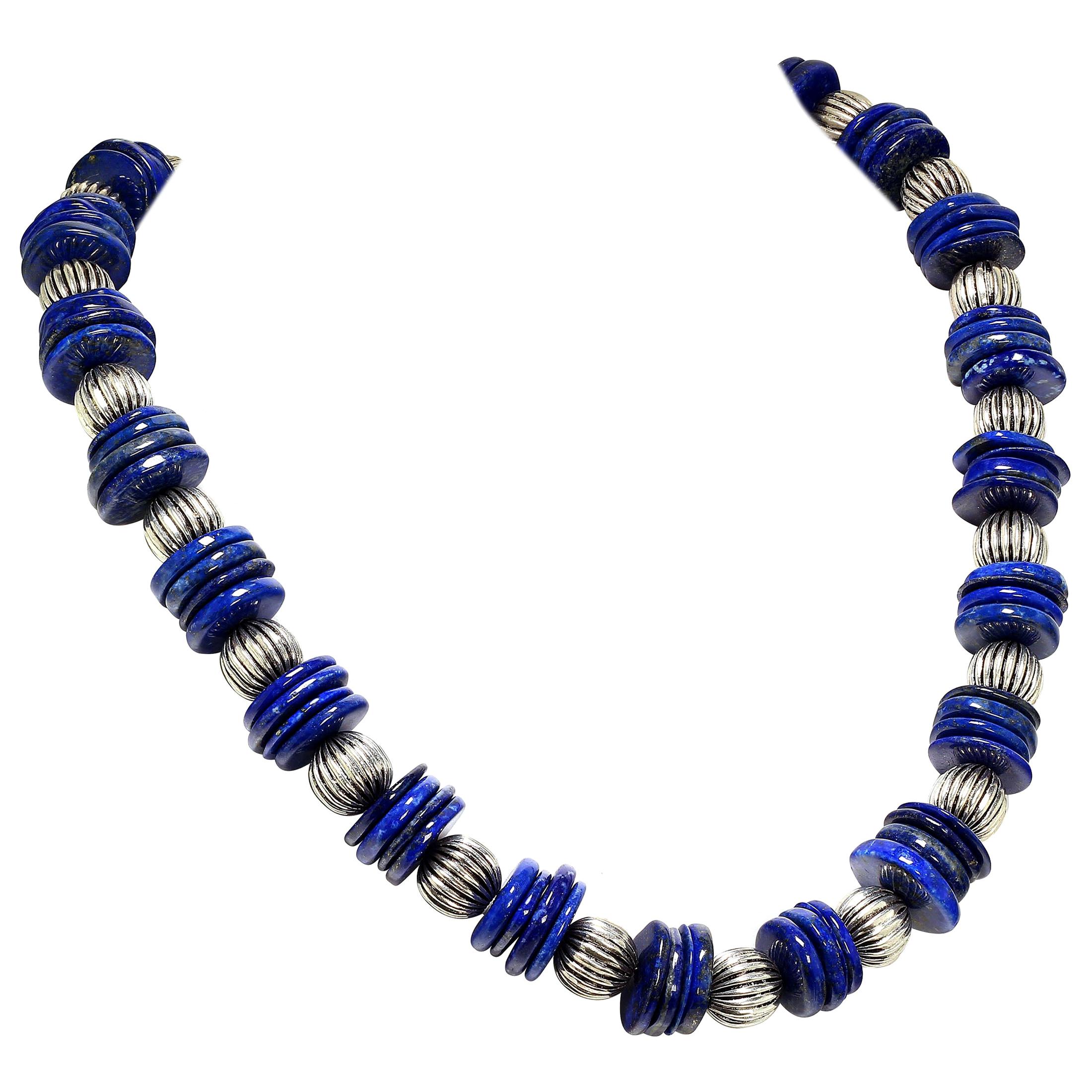 This is your new 'go to' Lapis necklace!  At 26 inches you will love wearing this elegant Lapis Lazuli statement necklace.  We have alternated groups of 18 MM Lapis slices with ribbed silver tone accents (14 MM).  The hightly polished Lapis slices