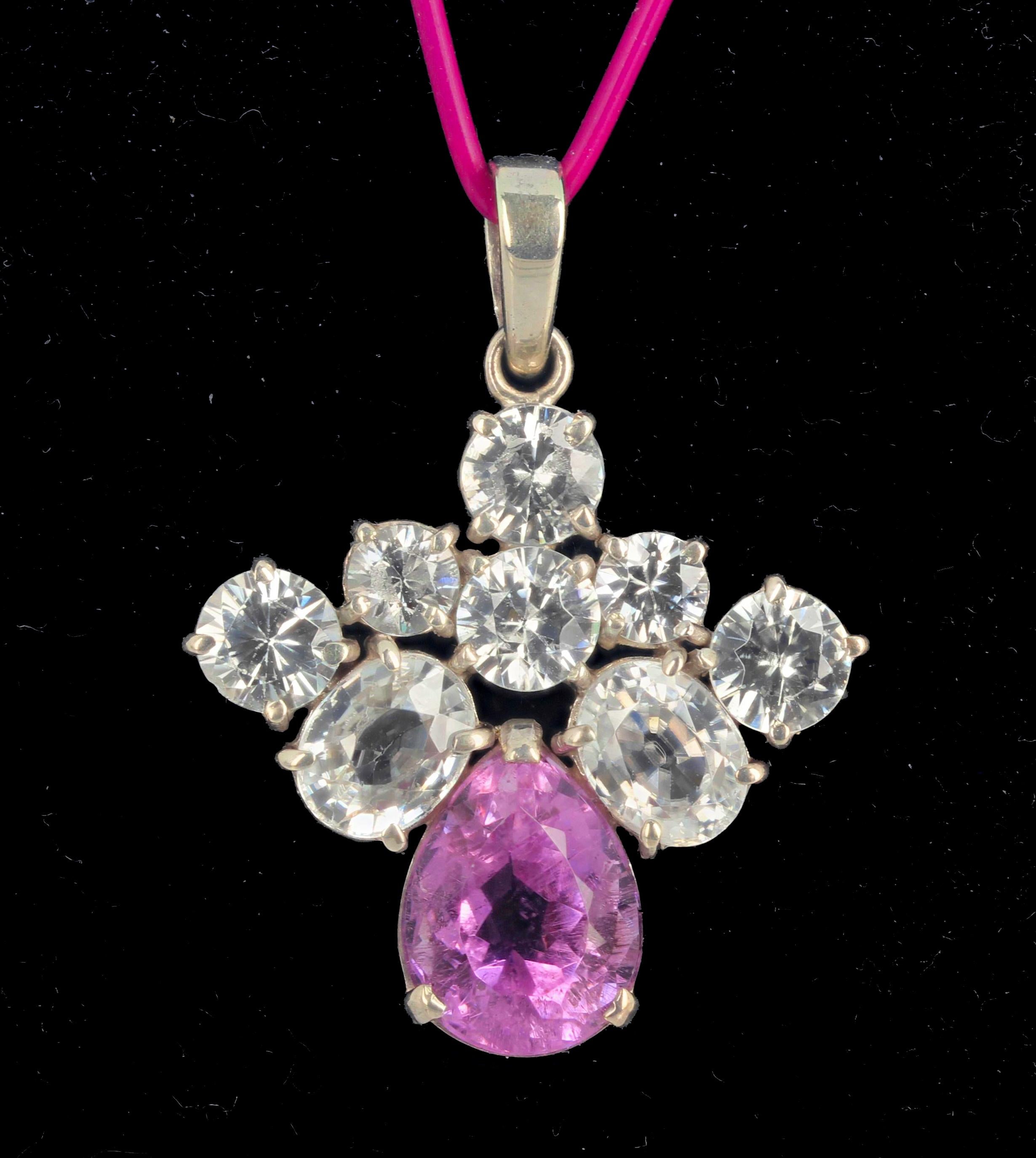 This beautiful 7.6 carat Kunzite is 14.3 mm. x 11 mm and is enhanced by brilliant glittering natural gem cut White Topaz and sits 1 1/2 inches long from top of loop to bottom of Kunzite.   The sparkles are amazing. This was discovered in 1902 by