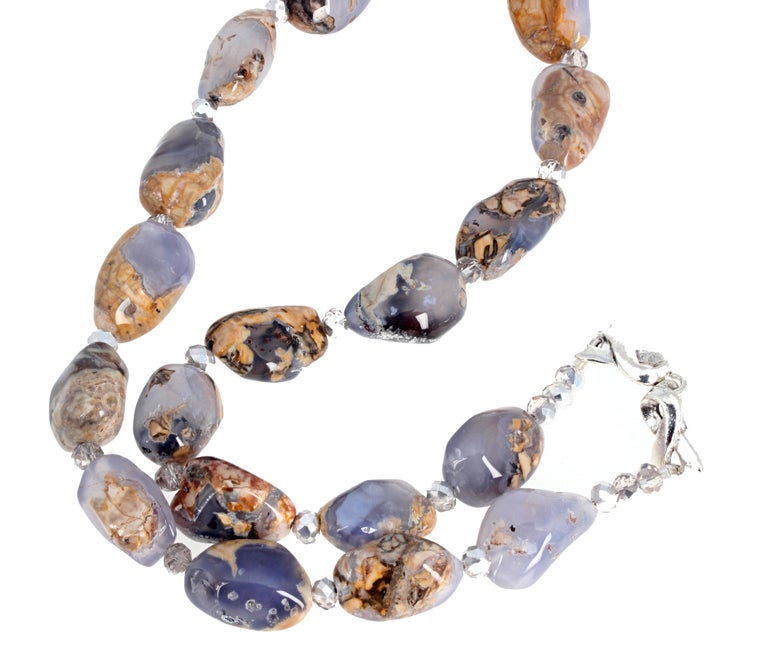 This lovely highly polished natural real Chalcedony gemstone necklace is 22 inches long with a silver plated easy-to-use hook clasp.  The largest ones are approximately 22mm x 15mm and are beautifully  translucent in the blue part.  If you wish