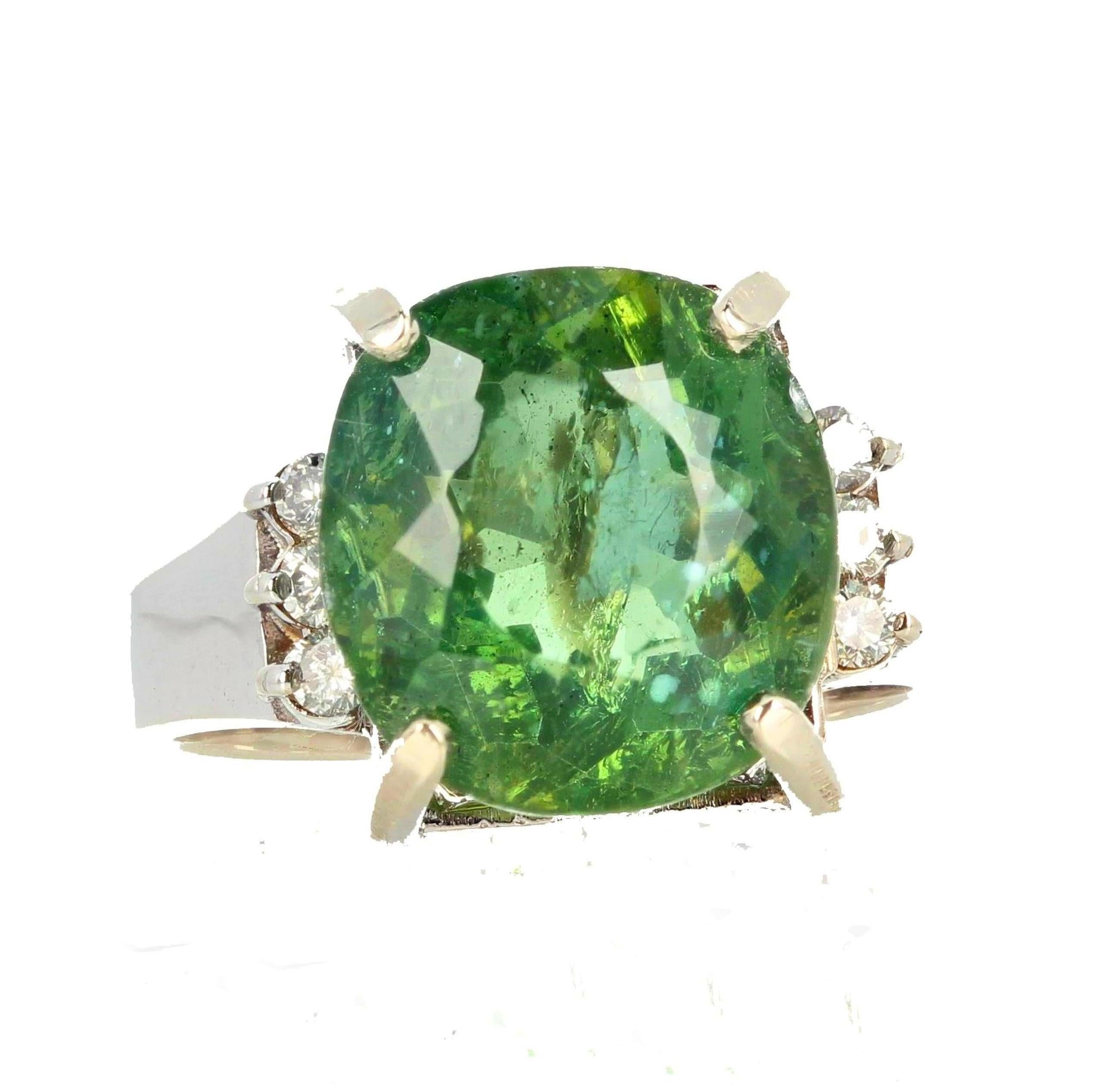This 8 Carat cushion cut glittering brilliant natural green Madagascar Apatite (12.5mm x 11.9 mm) is enhanced with 6 beautiful sparkling diamonds set in a lovely 14KT white gold ring size 7.3 (sizable). Spectacular optical effect in the Apatite