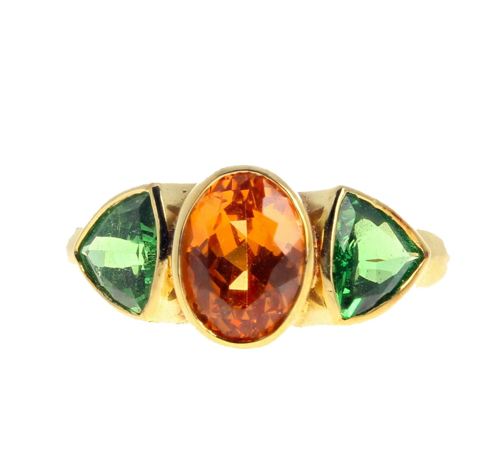 Beautiful center natural brilliant 2 Carat (exceedingly rare now) Spessartite (8.5mm x 6.3mm) enhanced with glittering green trillion Garnets (5.6 mm x 5.6 mm each and approximately 0.60 carats each) set in this 18K yellow gold ring size 7 (sizable