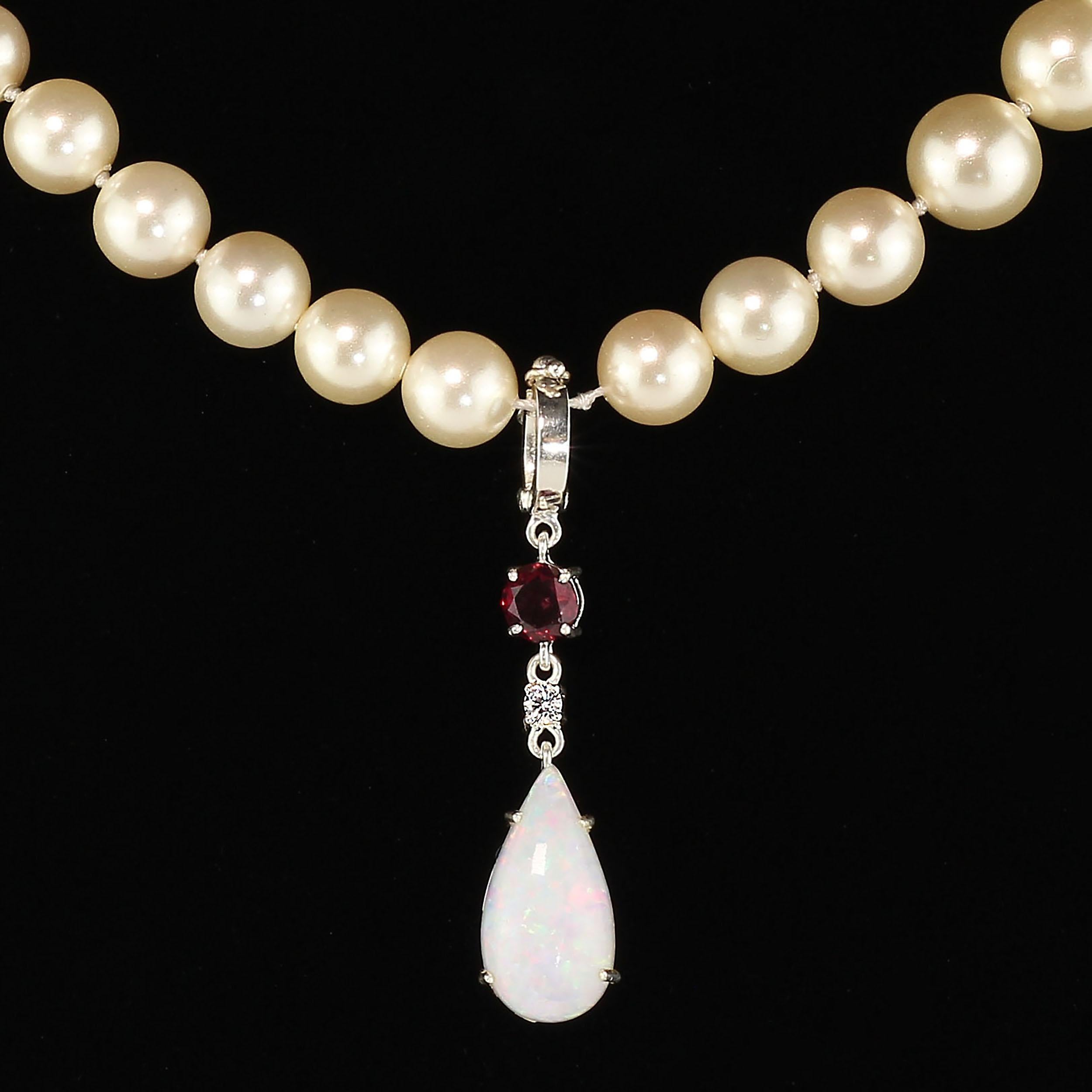 Gorgeous drop shaped Opal with flashes of red, blue, and green. How great is that?! This is so beautiful. This unique pendant is hinged for versatality so you can hang it on pearls, a narrow scarf, a chain, use your imagination. Below the hinge is a