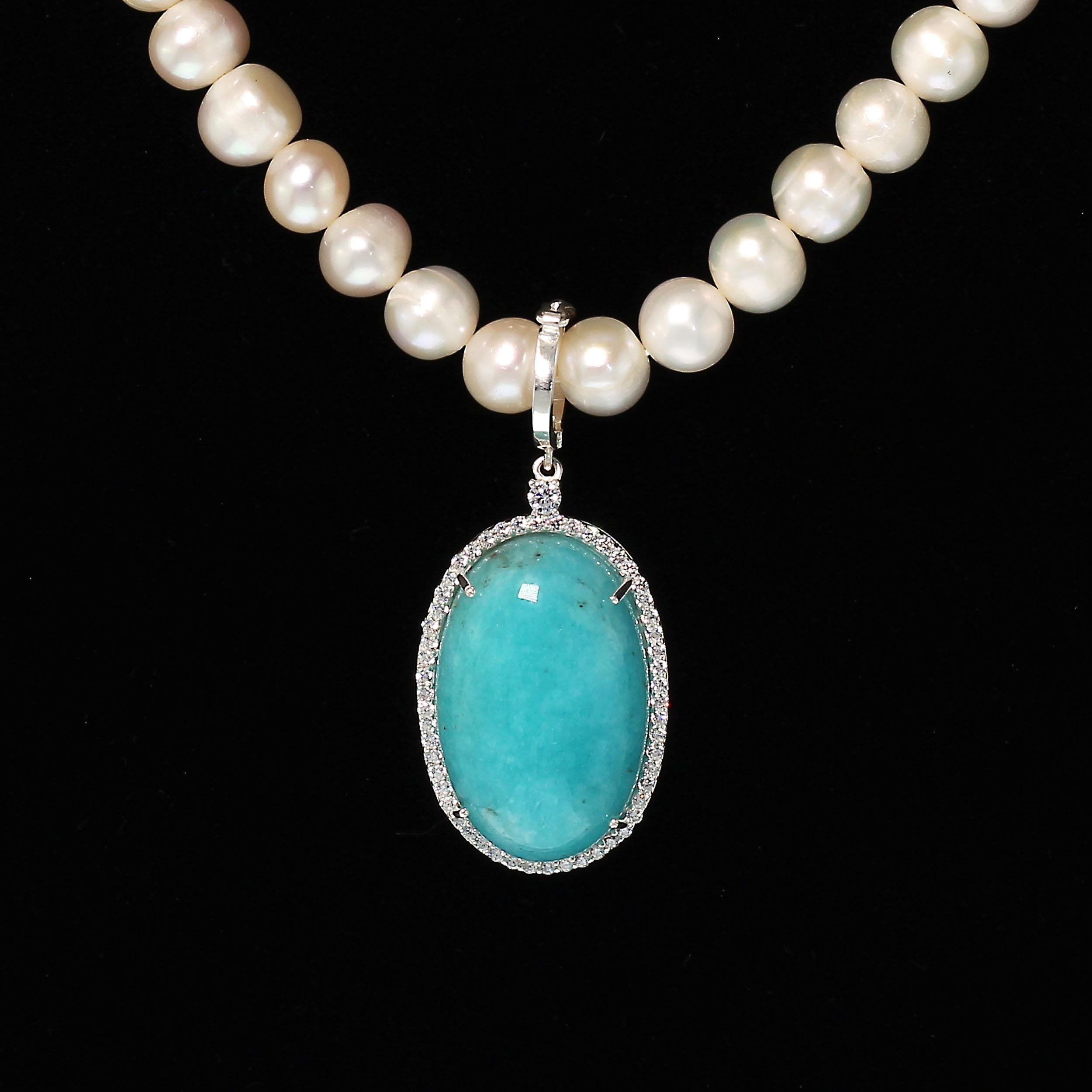 Elegant pendant featuring 33.40 carat highly polished Amazonite cabochon surrounded with sparkling Cambodian Zircons. This pendant is stunning. It is 1 7/8 inches in length with a hinged bail to easily fit on your favorite pearl necklace, chain, or