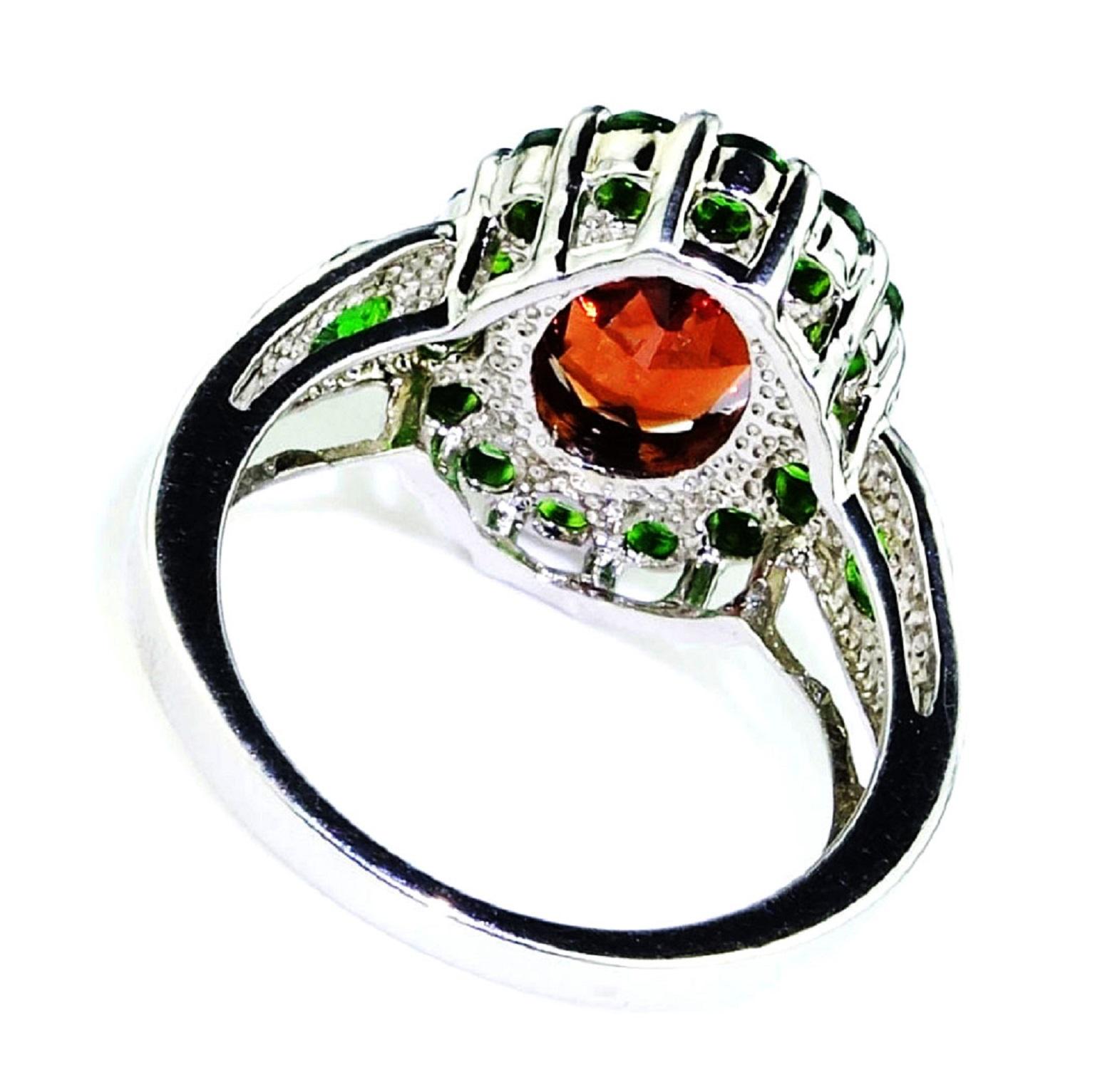 Stunning, custom made Sterling Silver Ring set with oval Sparkling Spessartite Garnet, 2.87ct, surrounded by round bright green Chrome Diopside. There are two more Chrome Diopside in the ring shank. TCW 1.47. This unique ring is a great way to show