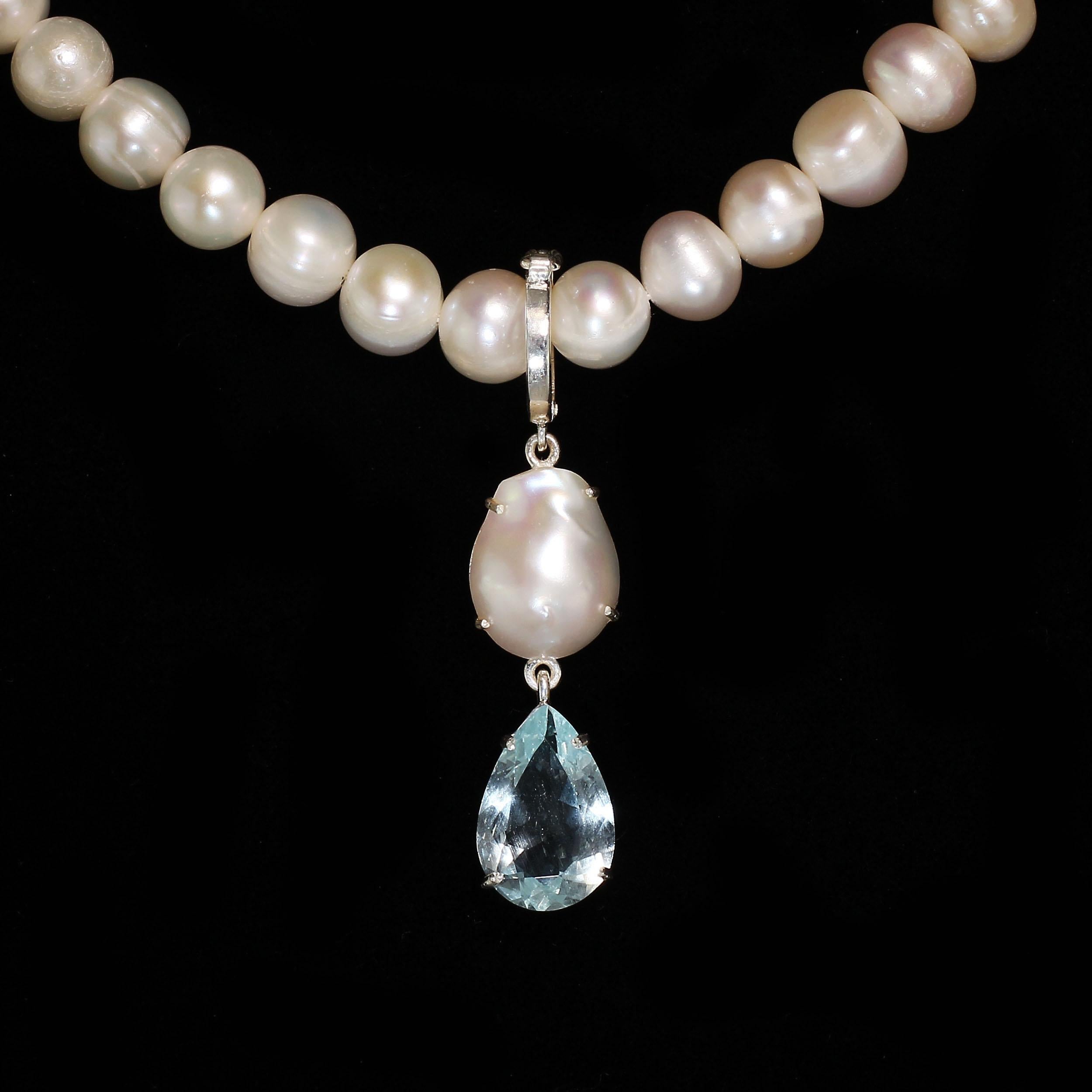 'Because you deserve to wear Pearls'

Lovely Blue and White Pendant featuring a pear shaped Aquamarine and white Baroque Pearl. This delightful pendant hangs from a hinged Sterling Silver bail which will fit over your favorite pearls, necklace, or
