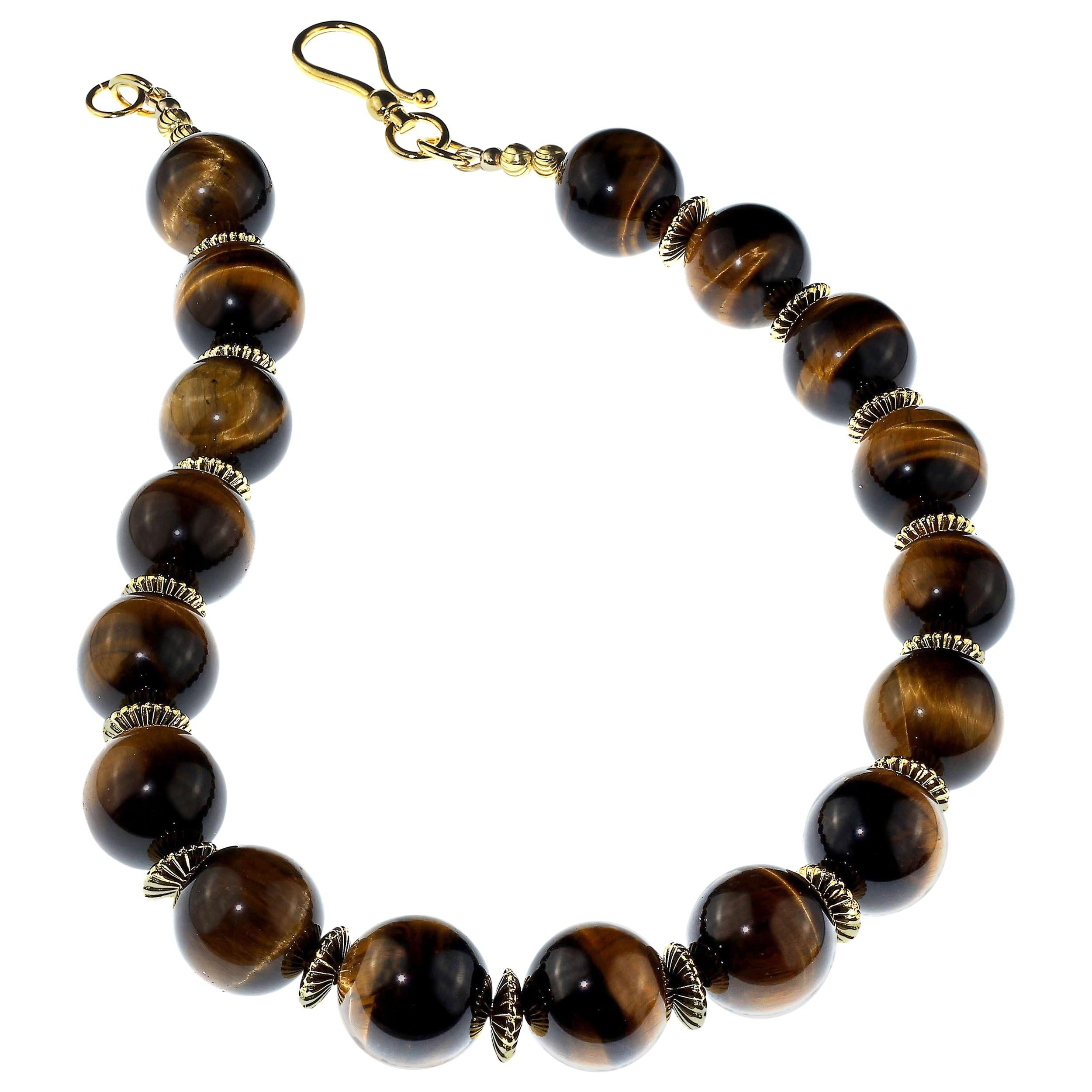 This is 19 inches of gorgeous Tiger's Eye necklace! This unique glowing 20 MM Tiger's Eye is enhanced with corrugated gold tone rondelles and a 24K gold Duro plate hook and eye clasp. This large hook and eye clasp makes it so easy to slip this one