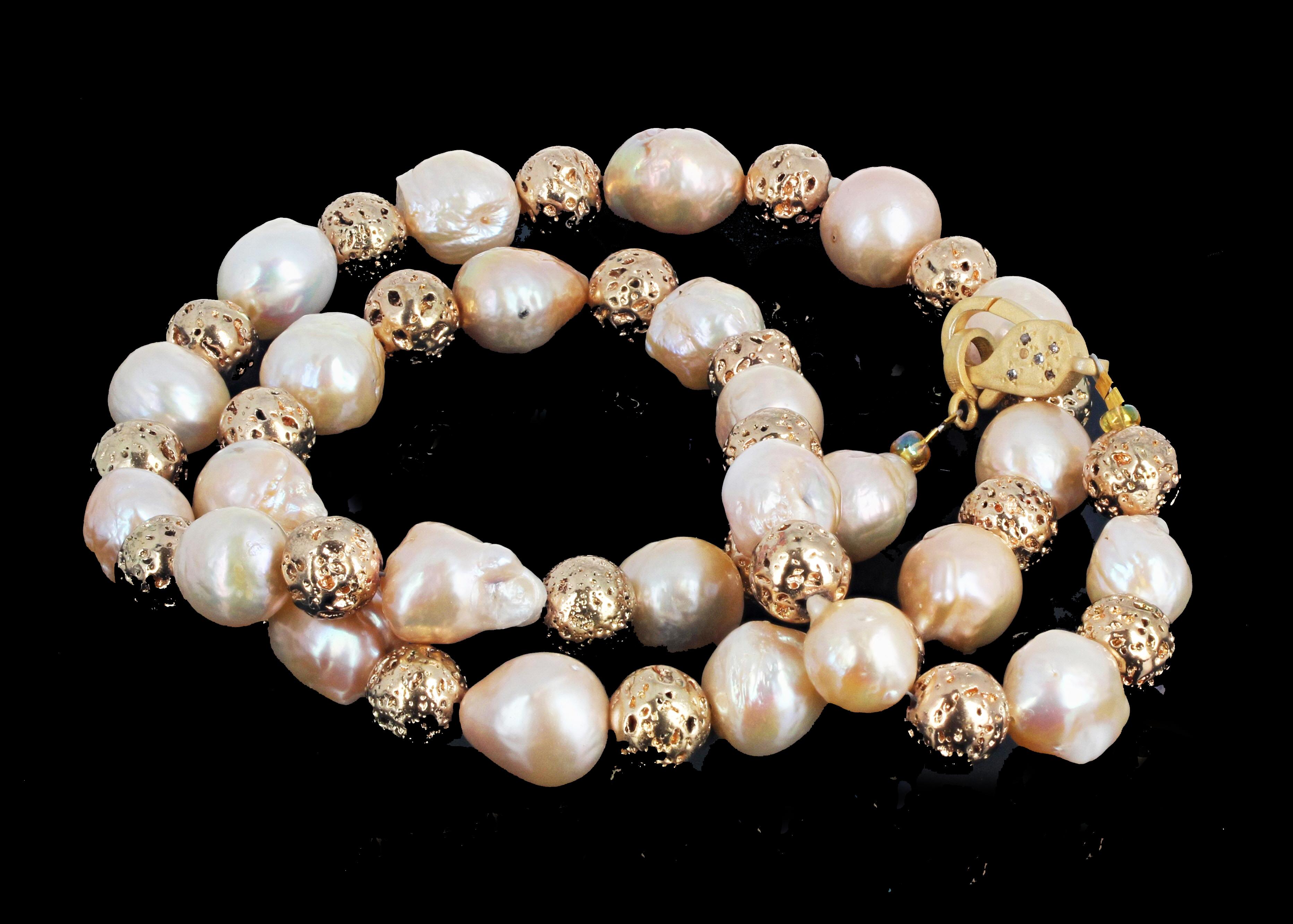 Large round Gold plated Lava Rock enhances these gorgeous slightly goldy tone natural ocean cultured Pearls in this magnificent 26 inch long necklace.  The clasp is gold plated silver set with real tiny brilliant white diamonds. The pearls, although