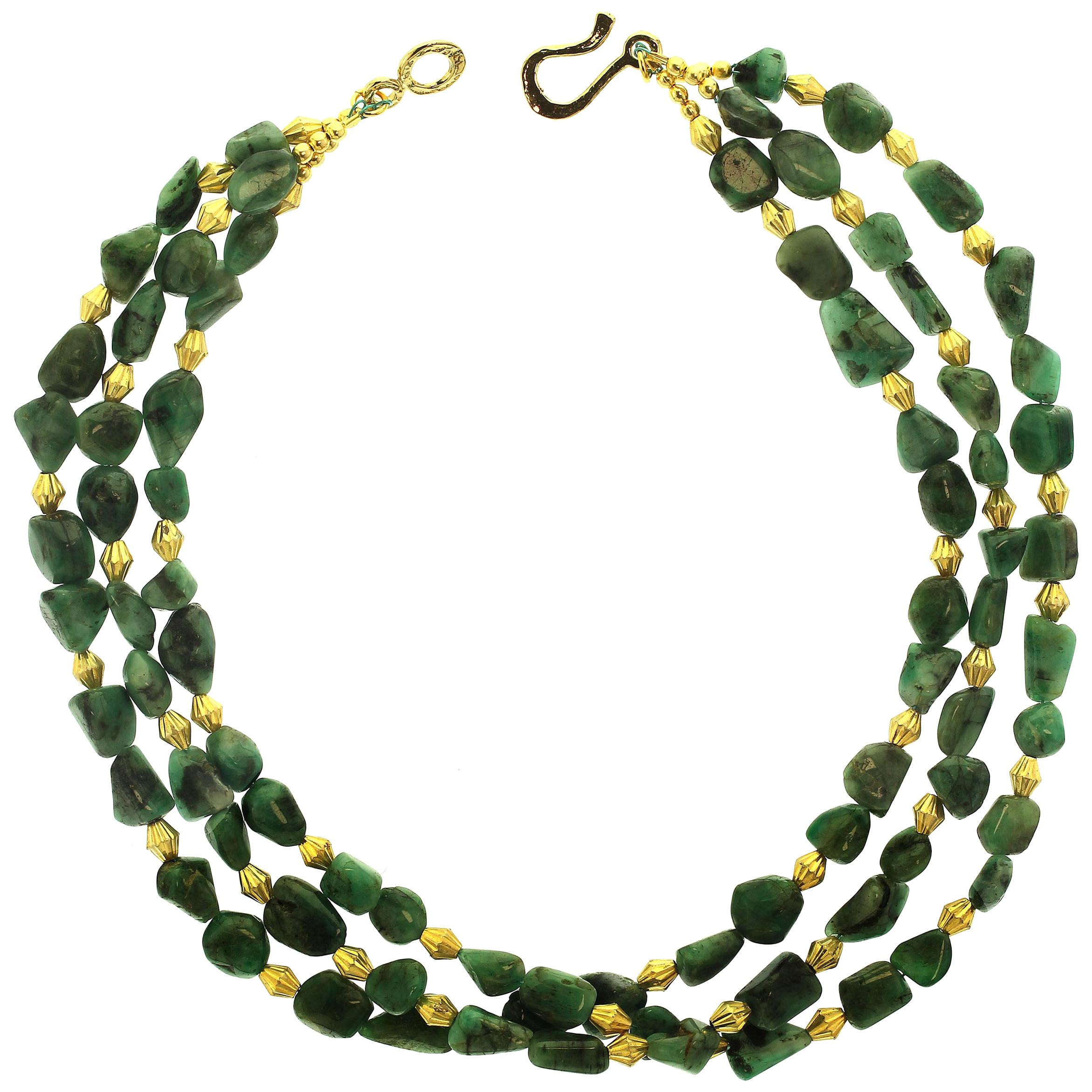 Choker necklace of three strand highly polished Emerald matrix nuggets with gold tone accents. This  necklace is approximately 14 inches in length worn as a choker. These Emerald in matrix nuggets are a variety of shapes and sizes and a lovely warm