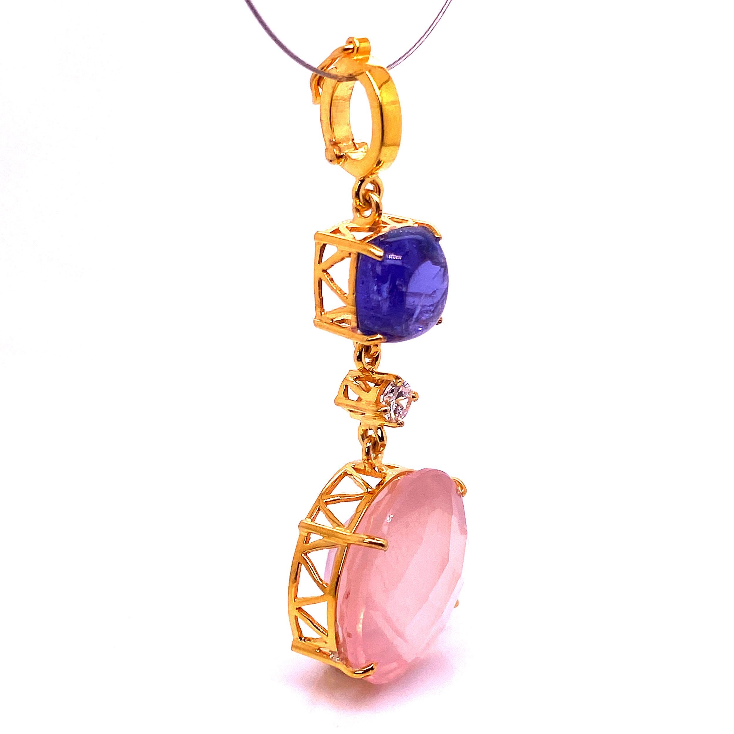 One of a kind, Rose Quartz and Tanzanite Pendant set in gold rhodium plated Sterling Silver.  This unique Gemjunky pendant is 2.25 inches in length from its hinged bail to the base of the round 20.44 carat checkerboard table Rose Quartz.  The 5.57