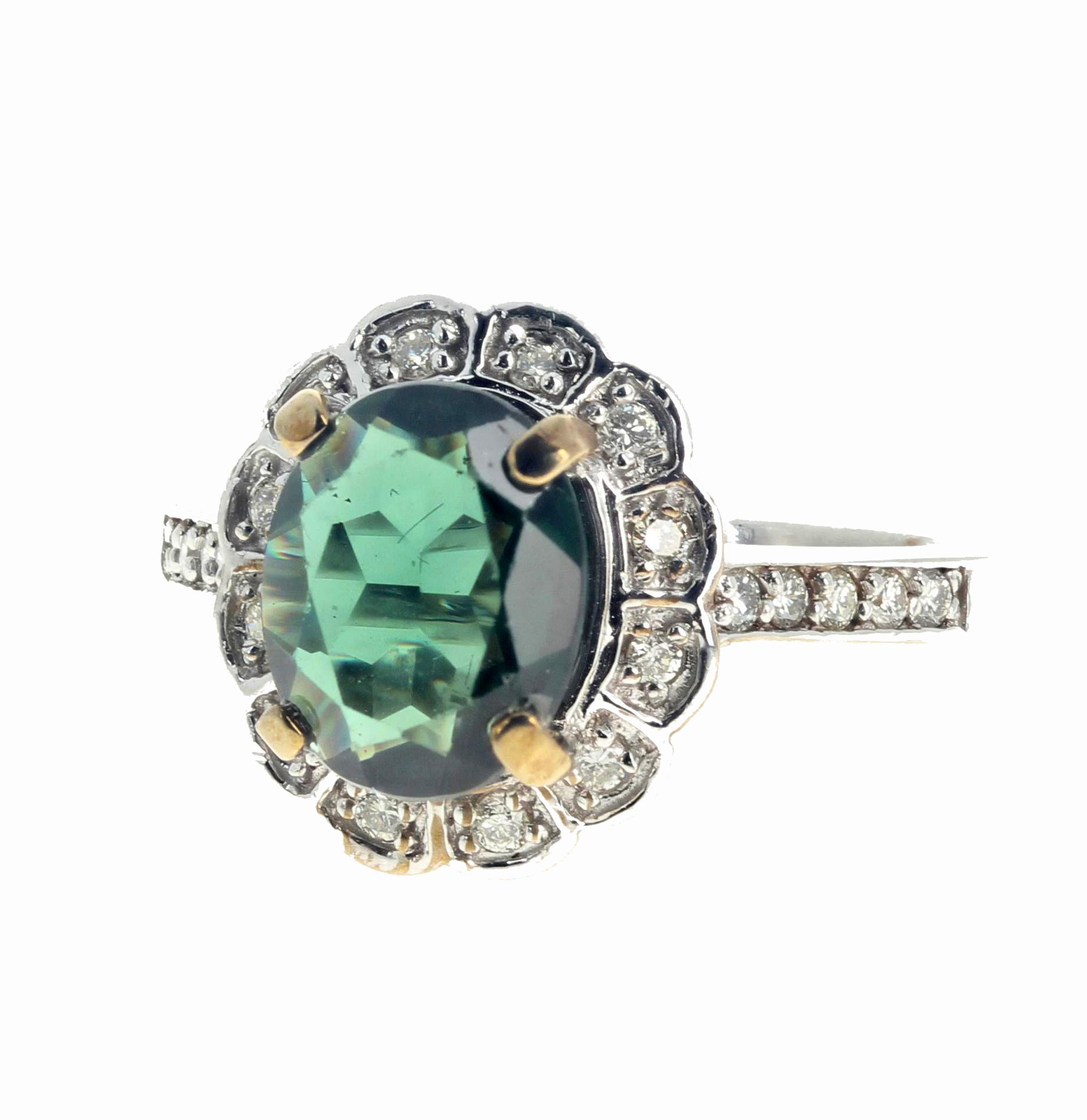 This very intensely green 2.23 carat natural Apatite from Madagascar (10 mm x 8 mm) surrounded by .31 carats of real little round white brilliantly sparkling Diamonds is set in this 14K white gold ring size 7 sizable for free.  
