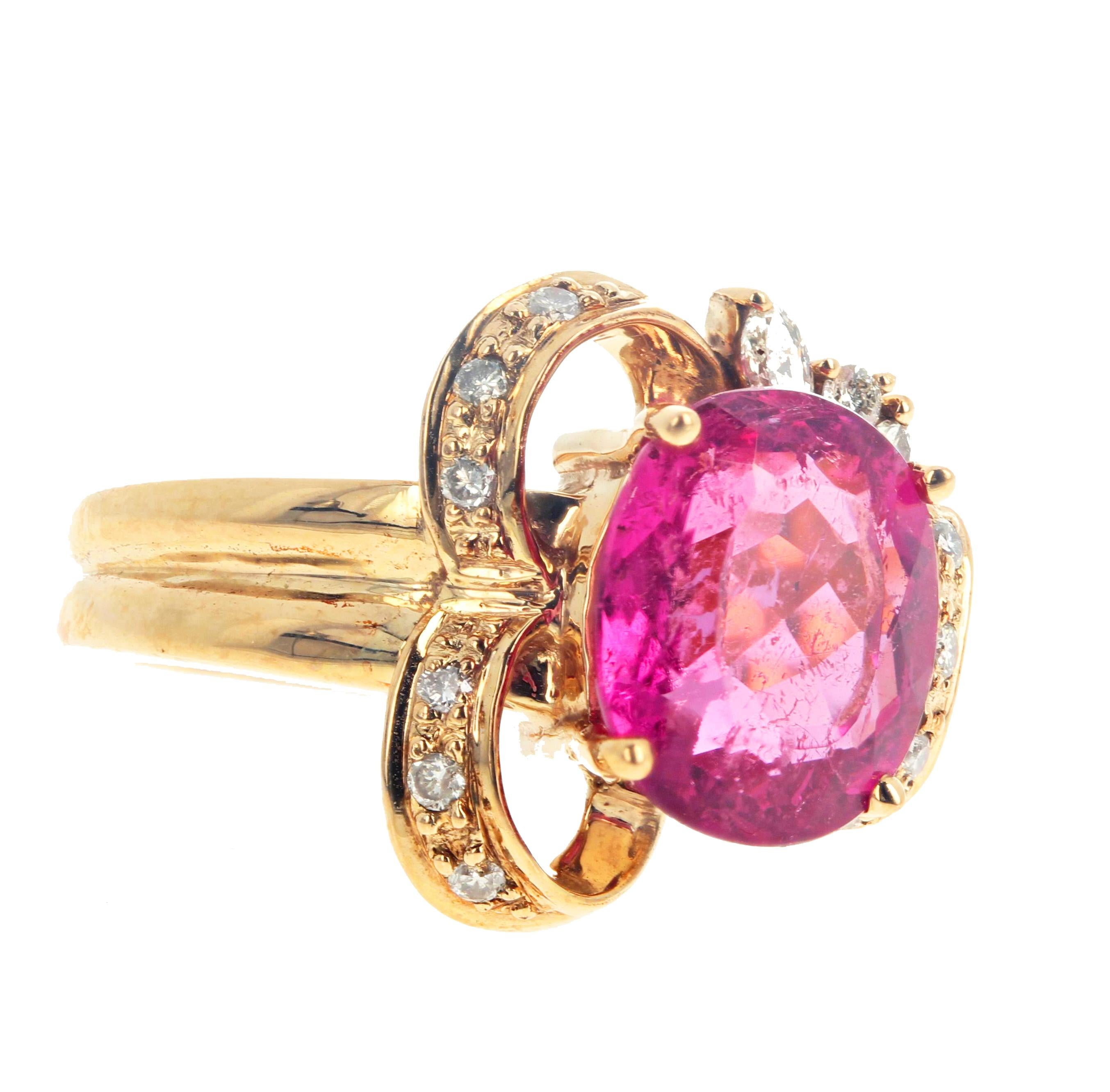 This beautiful ring setting replicates the shape of a bow with small sparkling white diamond enhancements and a magnificent center 3.7 carats oval Rubelite Tourmaline (10.4 mm x 9 mm).  This beautiful unique ring is a size 7 sizable for free.  It is