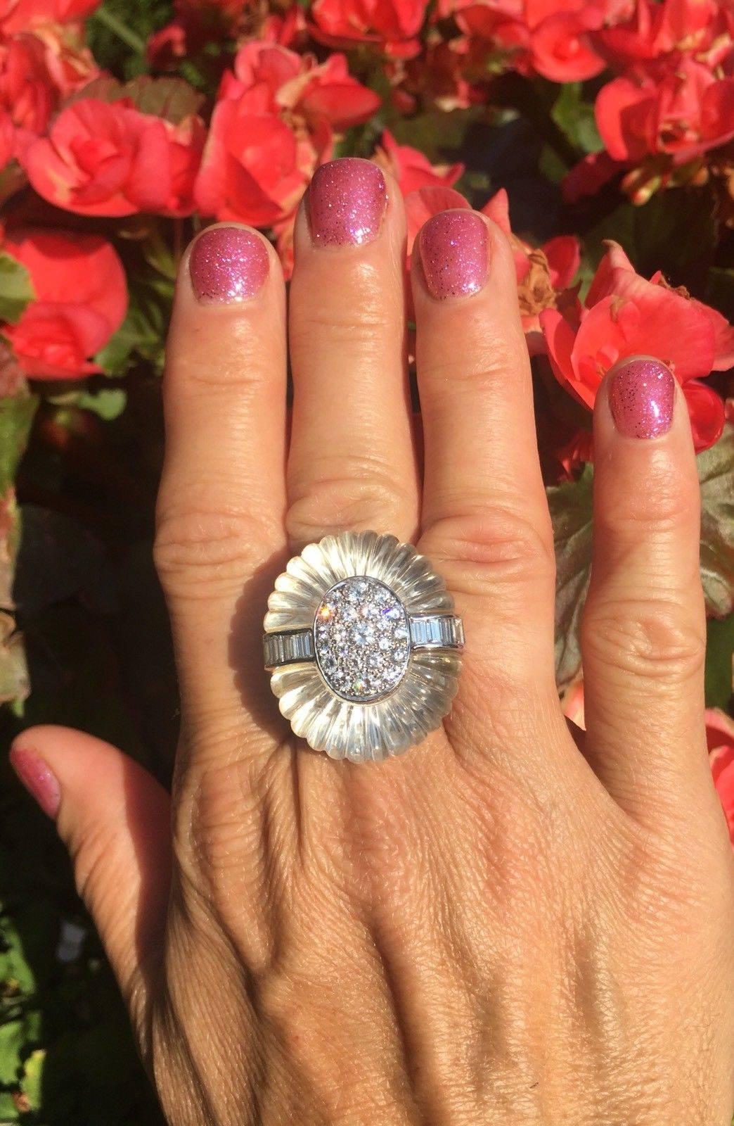 This impressive ring is part of a set of carved rock crystal and diamonds. The 18k white gold ring is a bombé design set with a pavé-set circular-cut diamond center flanked by a row of channel-set baguette diamonds, total estimated weight of 2.75