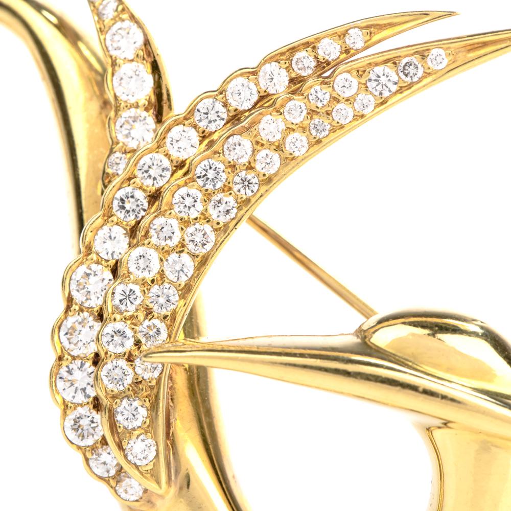 This extremely well-made diamond bird brooch is crafted in 18-karat yellow gold By GEMLOK, weighing 15.2 grams and measuring 51mm wide x 37mm long. Simulating a bird with a long-pointed beak and swirled feathers prong-set with 61 round-cut diamonds,