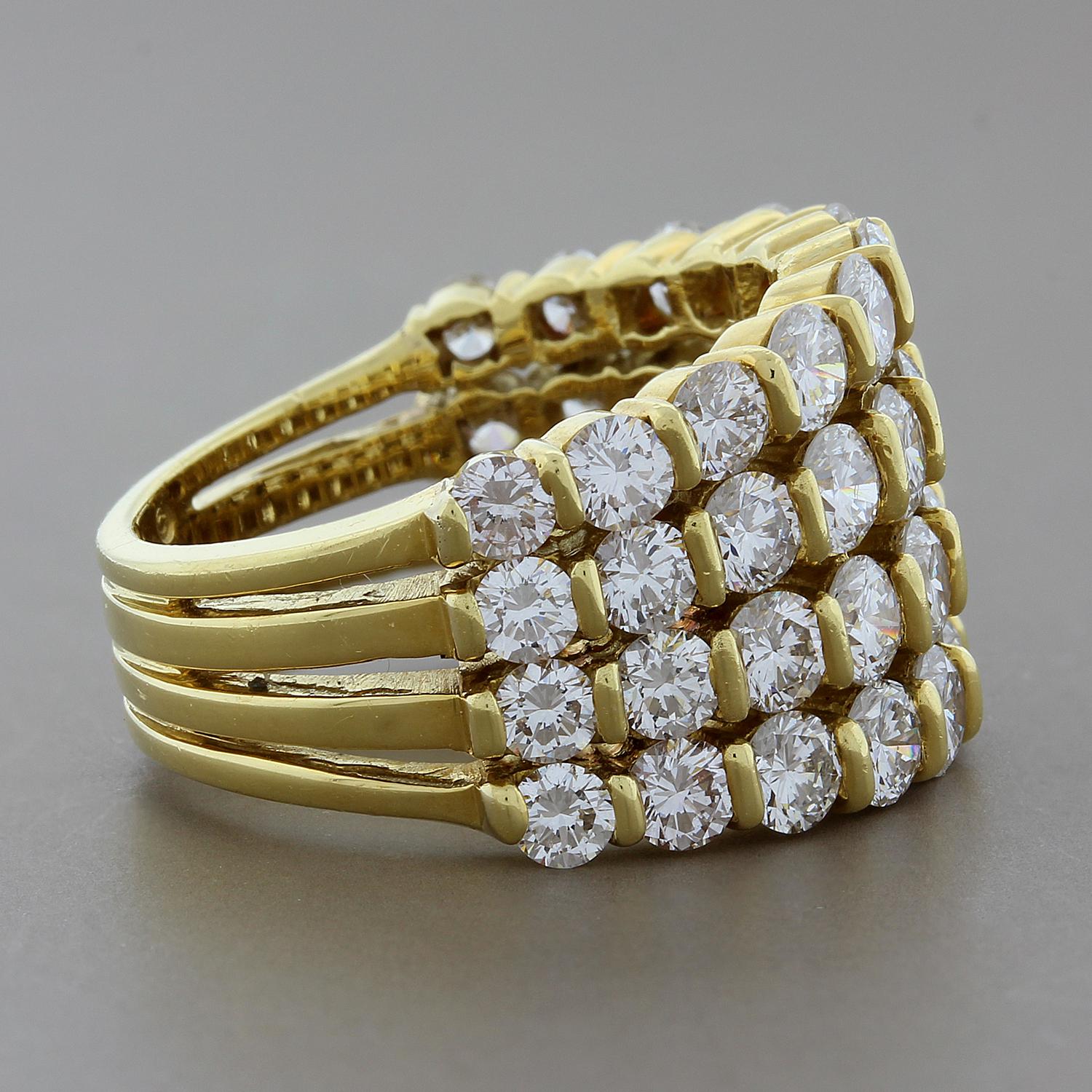 This brilliant band by Gemlok features 4.40 carats of round cut VS quality diamonds. Each diamond is uniquely channel set in 18K yellow gold on four bands that merge into one seamlessly finished band. The diamonds are set half-circle for a