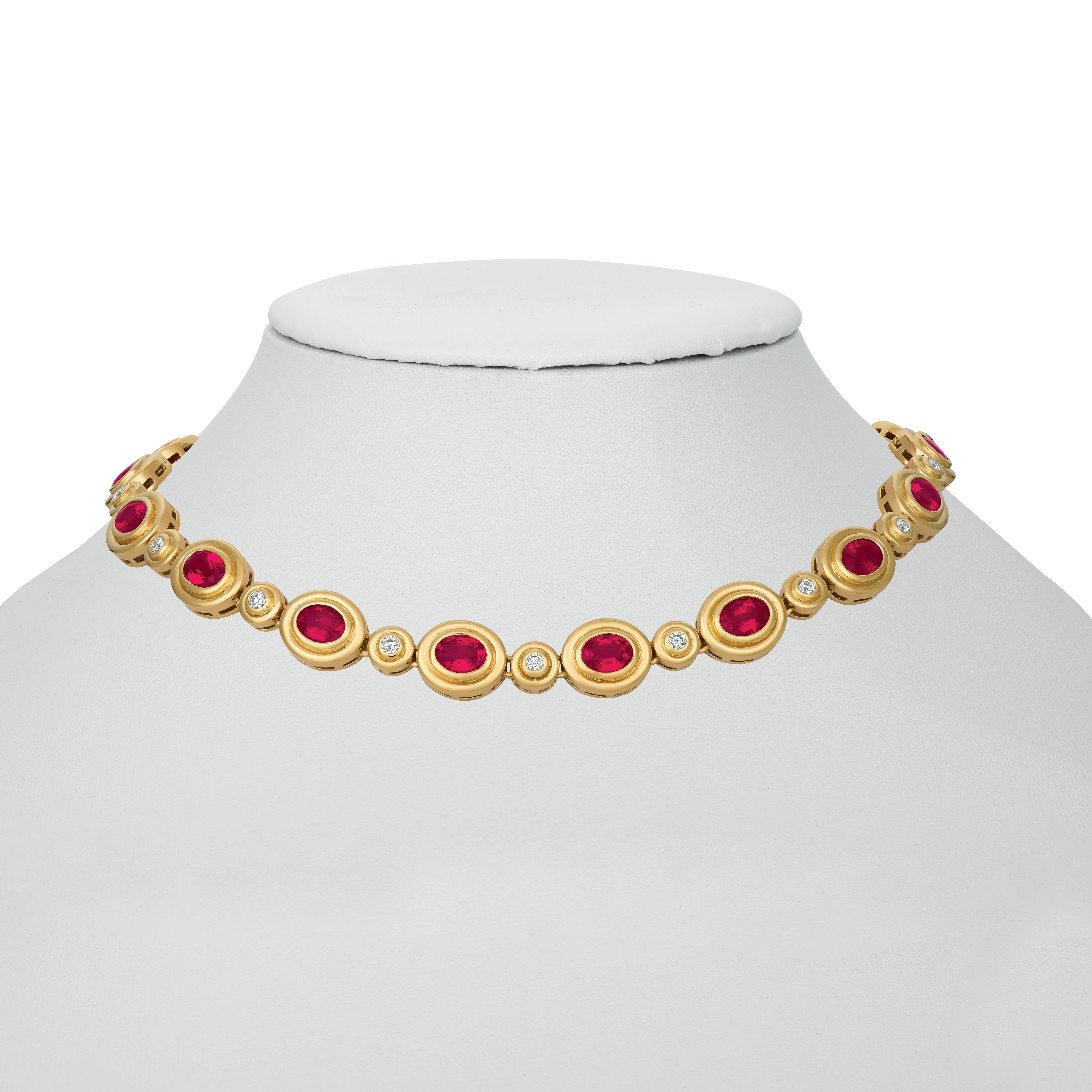Classic, clean line 18 karat yellow gold necklace. This tailored piece, set with 21.00 carats of gem quality oval Rubelite each separated with a diamond totaling 1.80 carats, is an easy everyday wear.