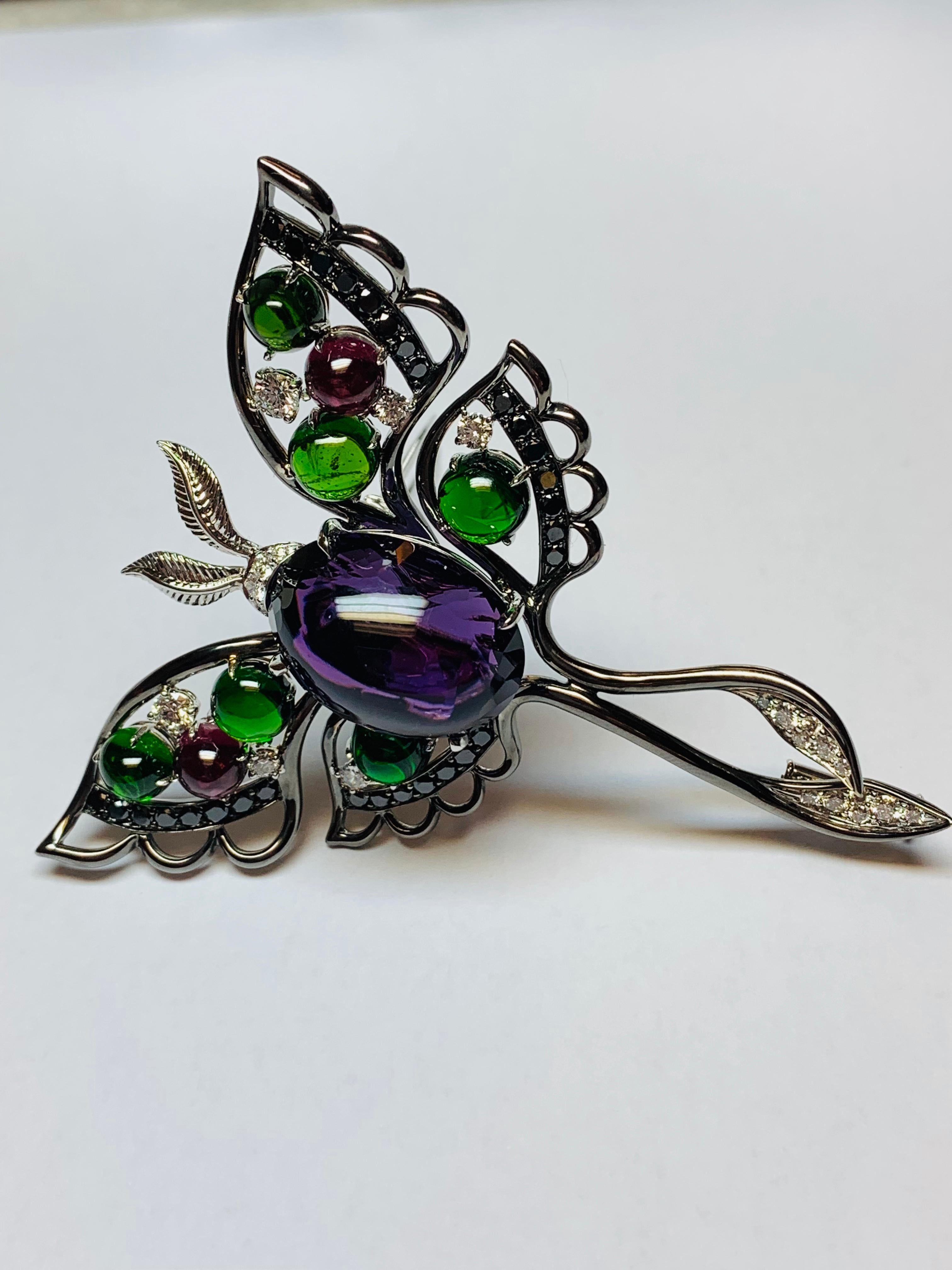This one off piece is magnificent! Highlighted with a large cabochon cut Amethyst in the center, surrounded by cabochon Chrome Tourmalines and Rhodolite Garnets and finished off with a sprinkle of Black and White diamonds. We have Oxidized (