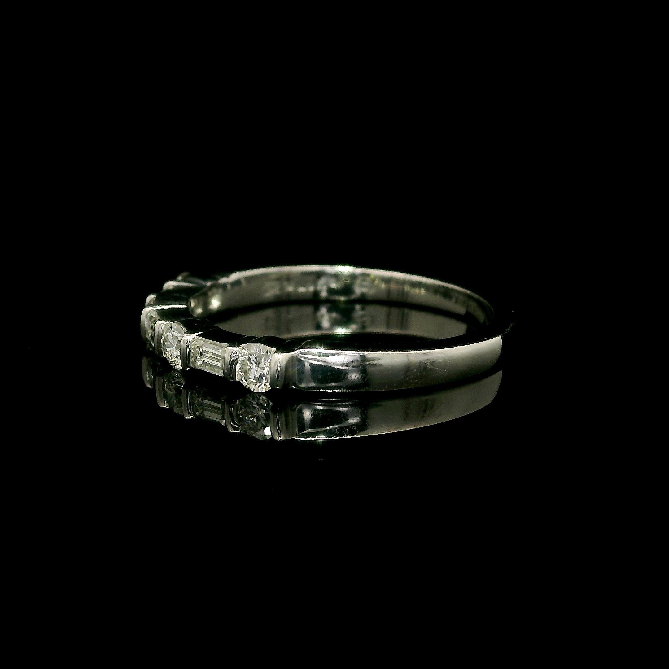 –Stone(s): –
(7) Natural Genuine Diamonds - 4 Round Brilliant & 3 Emerald Cut - Channel Bar Set - G/H Color - VS1/VS2 clarity - 0.55ctw (approx.)

Material: Solid .900+ Platinum (tested) - Stamped PLAT
Total Weight:  3.83 Grams
Overall Width: 2.5