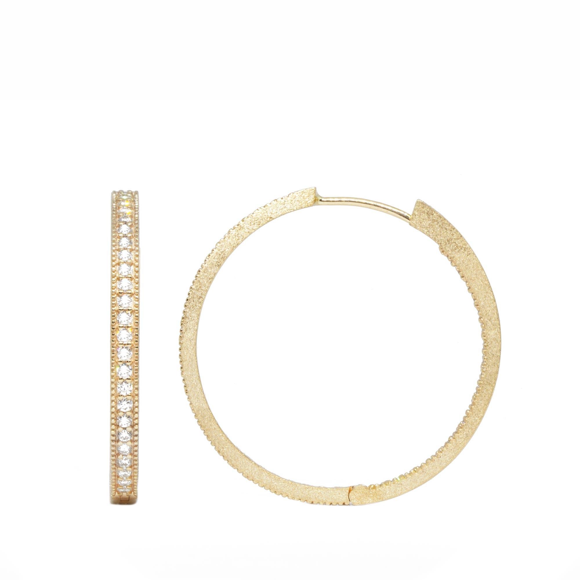A slender—and lightweight—version of our Large Gold Hoop Earrings, with smooth polished edges and delicate gemstones (but you still get a lot of sparkles and shine). Customers love this style for piling on earring charms; one popular look is to wear
