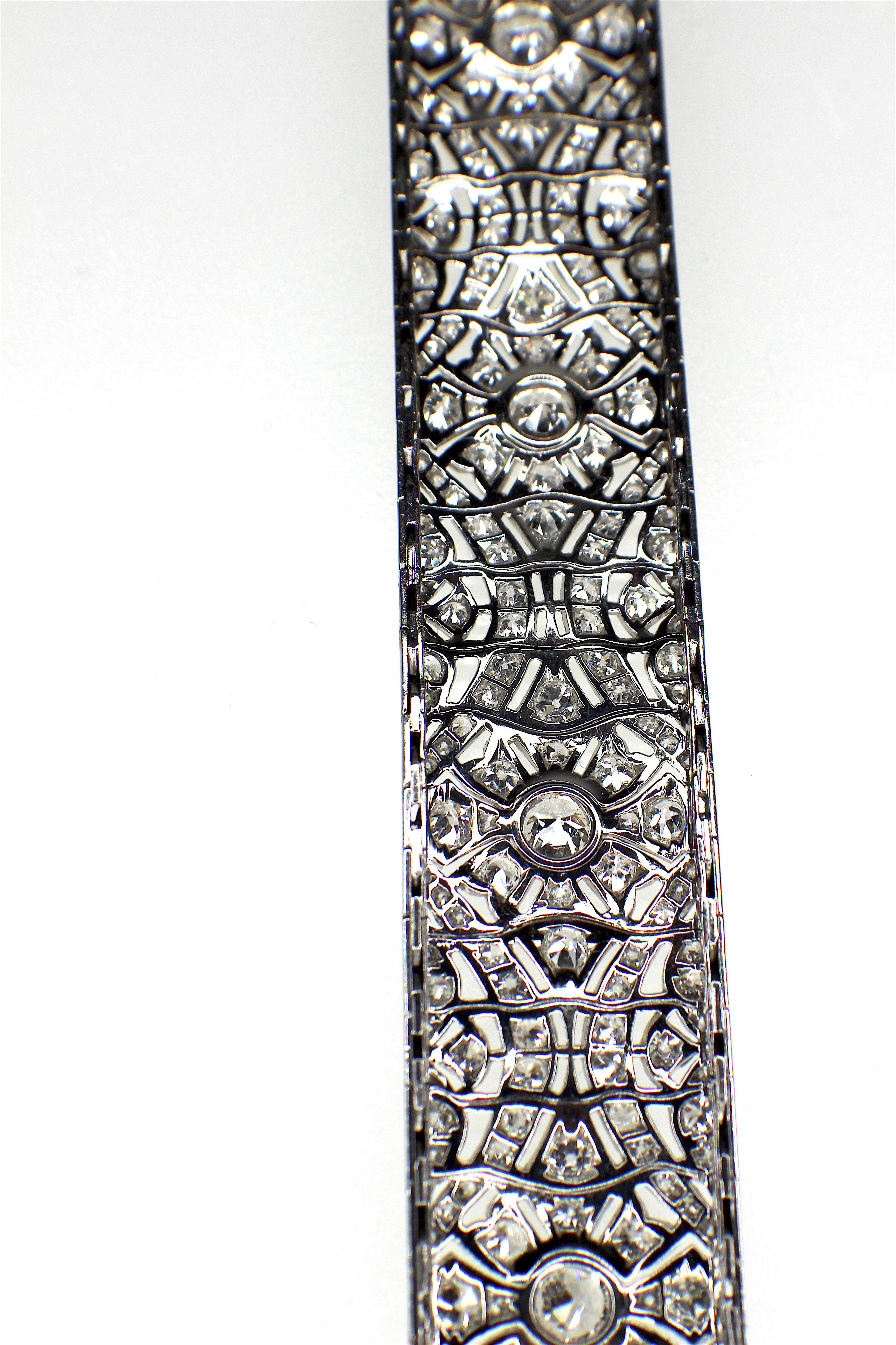 GEMOLITHOS a French, Art Deco diamond bracelet, in a wavy flower design, set with old-cut and eight-cut diamonds, millegrain setting and engraved sides, mounted in platinum, circa 1920's. French marks 