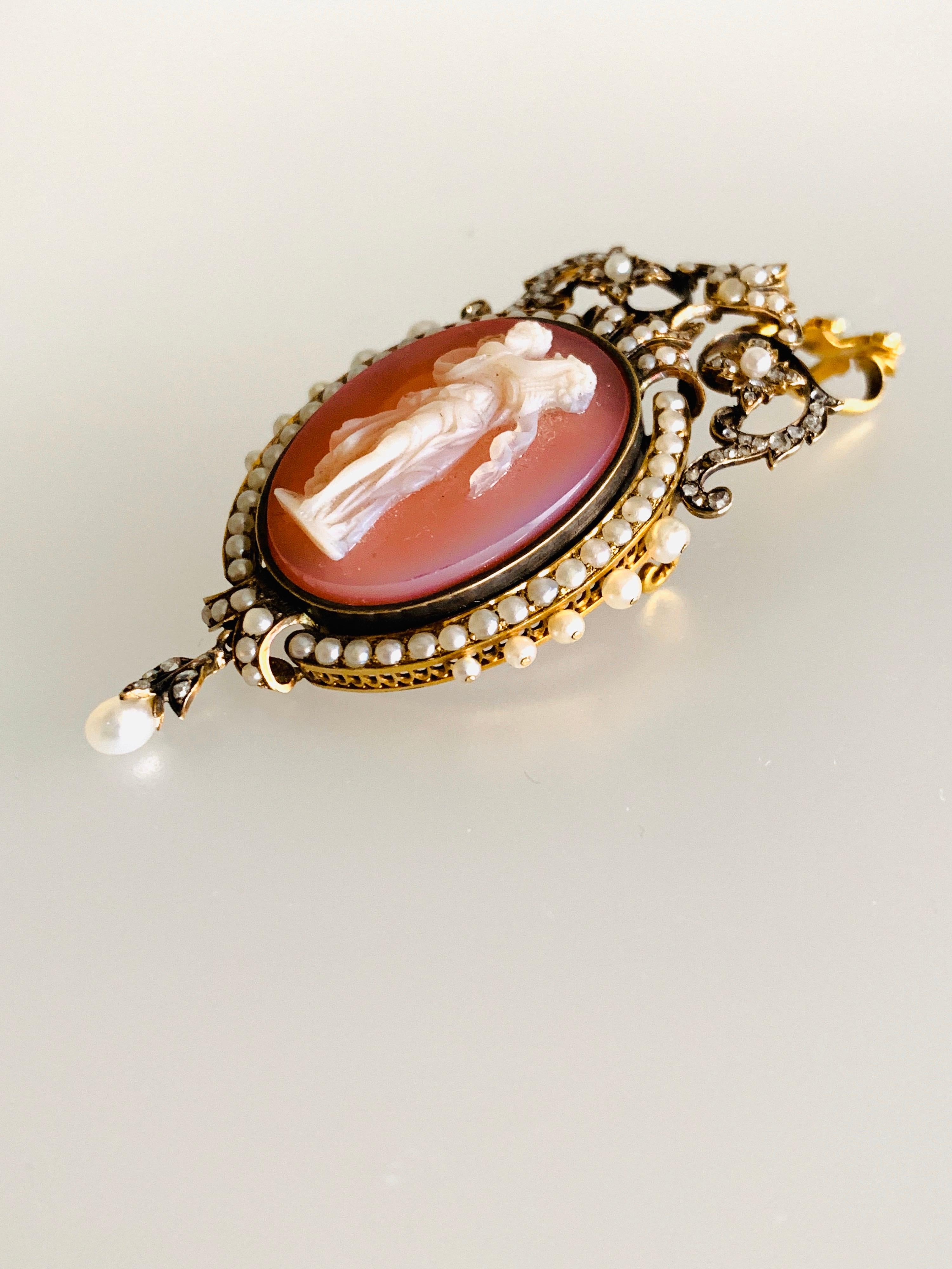 Gemolithos, Victorian, hardstone cameo, pearl and rose´-cut diamond pendant-brooch. 
Circa 1880s. Measurements 85x37mm, weight: 27,3gr. 