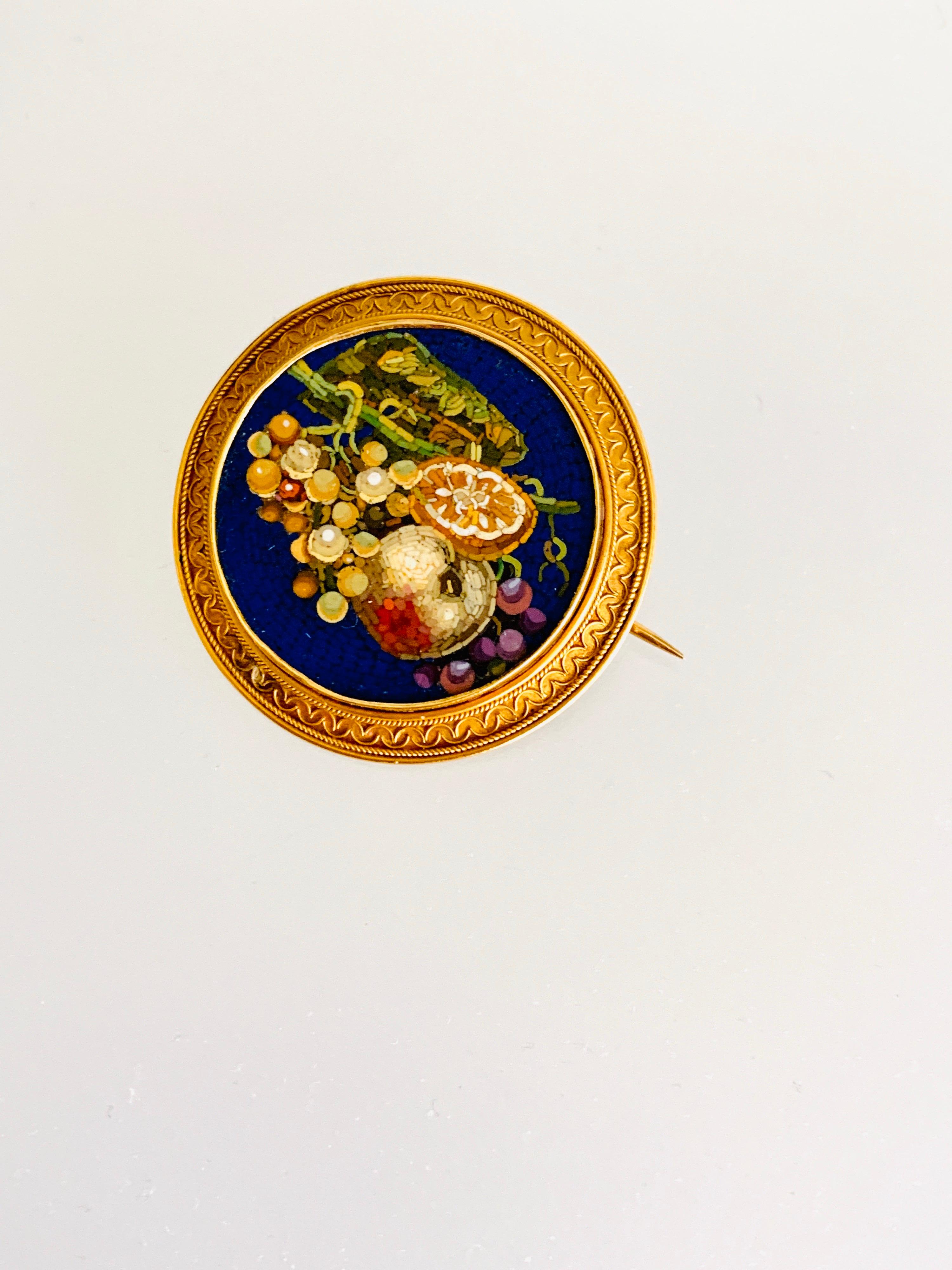 Gemolithos, Victorian micro mosaic brooch, circa 1860s. 18K gold and metal base, diameter. 36mm, 
weight 12.51gr. 