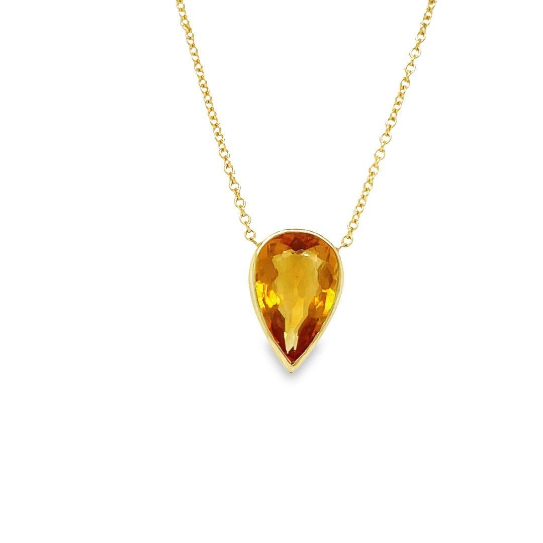 This necklace is crafted in 18-karat white gold and showcases a gorgeous pear-shaped citrine weighing approximately 4.00 carats. The citrine has a warm golden orange color and is elegantly set in a high polish bezel made of 18K yellow gold. It's a