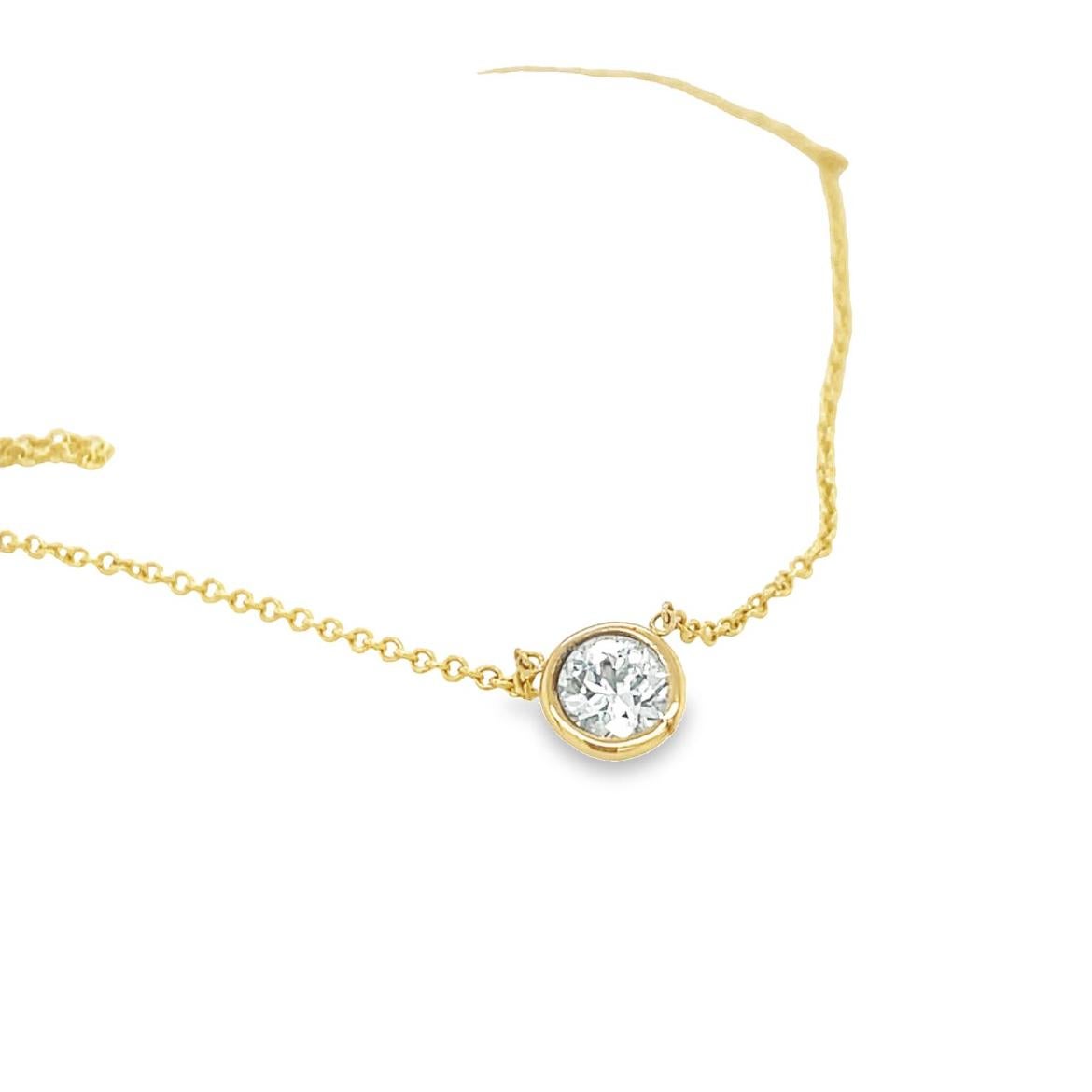 Ideal for your everyday signature necklace, this lovely  pendant necklace come set in 14k yellow gold metal with a sleek bezel setting and breathtaking round-cut diamond with a total weight of 0.18 ct. color G & VS clarity. The chain is a delicate
