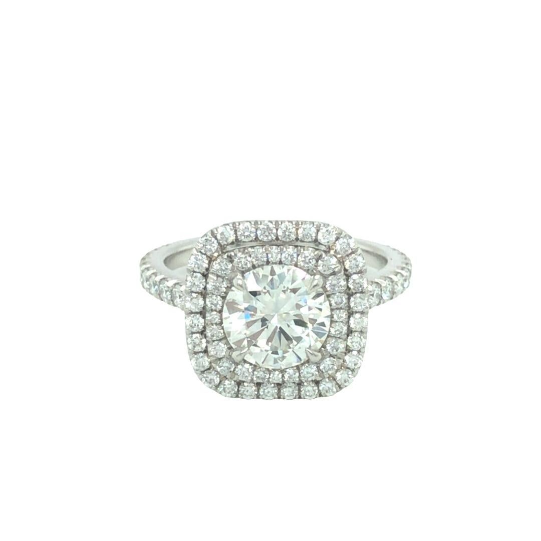 Modern elegant diamond engagement ring with 1.49 carat round brilliant diamond at center. The diamond is certified by EGL Laboratory with I in color and SI1 in clarity. Double halos of small colorless diamond wrap around the center stone creating a