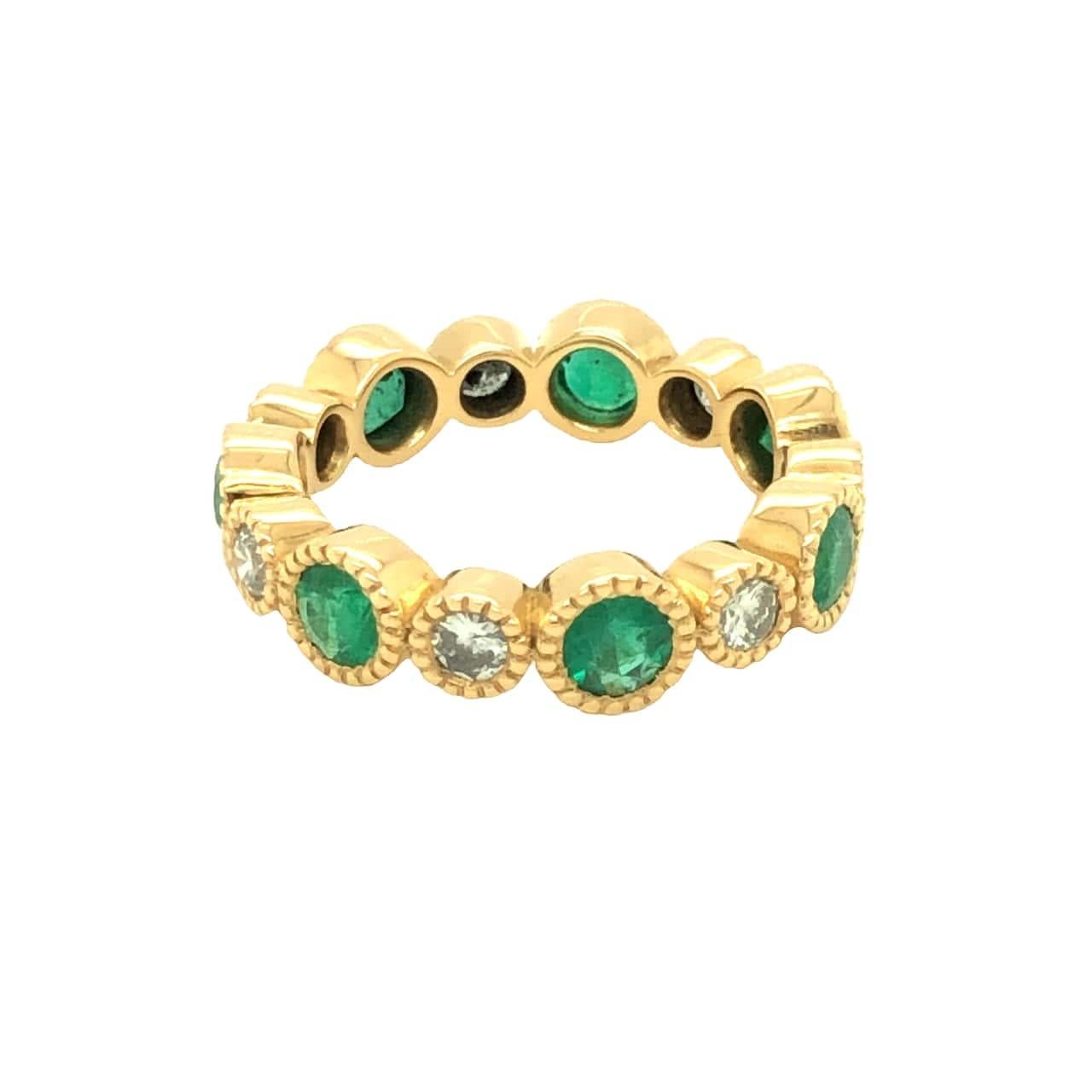 Custom order. Production time 2-3 weeks. Handcrafted in Beverly Hills by our master jeweler at Gems Are Forever, Inc. , this beautiful wedding band / eternity ring features round cut emerald alternating with round brilliant diamond. Each stone is