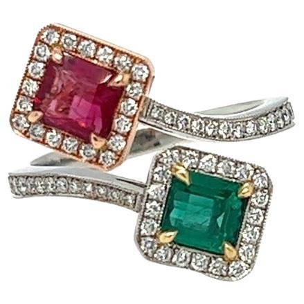 To Beryl lovers and gems collectors - this magnificent ring features one of the rarest gemstones, a red beryl. It is set juxtaposed with a step-cut square-shaped emerald highlighted by colorless diamond halo on a handcrafted bi-color setting. The