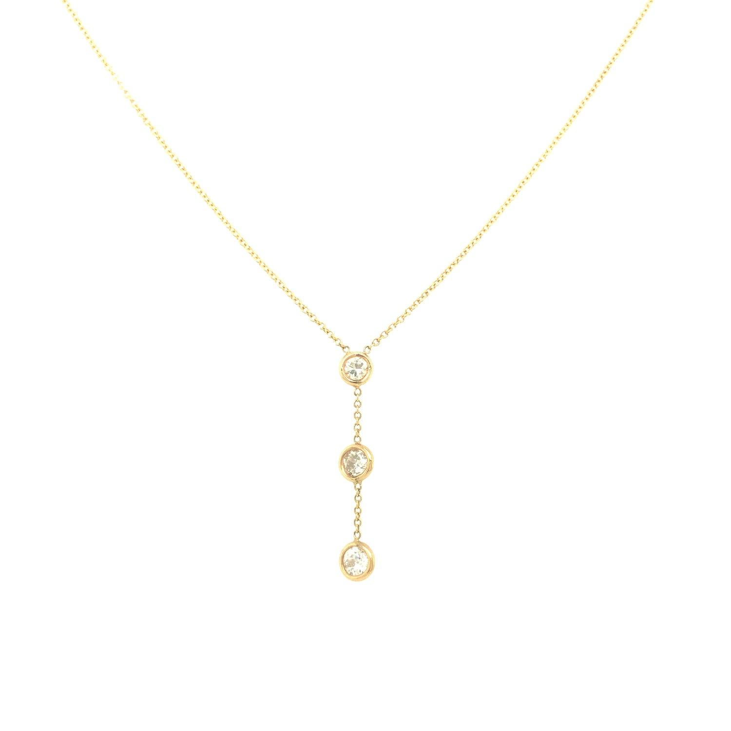 This sweet and fun Y-shaped necklace features three round brilliant cut diamonds set in bezel setting, dangling on 14K yellow gold simple chain. The diamonds weigh 0.50 carat total weight and are G-H color and VS2-SI1 clarity. The necklace measures 
