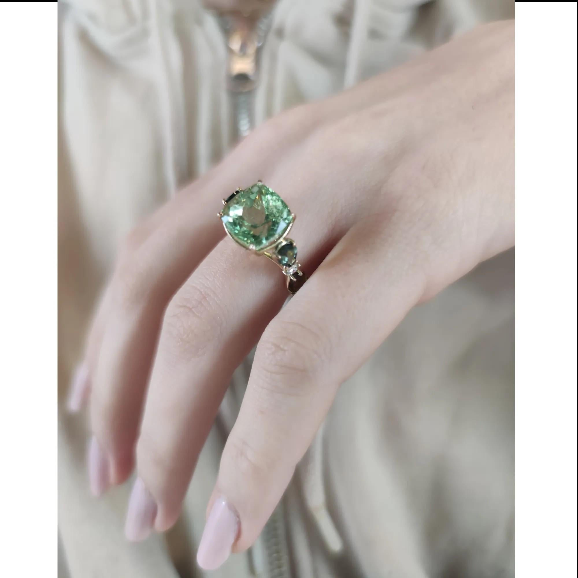 The 14 Karat Yellow Gold Ring is a unique, handcrafted jewelry piece with the following technical details:

SIZE:
To look at the photos with the scale ruler
-American Size:6.75
-European Size:14
  
Gemstones:
- One green tourmaline.
- Highly
