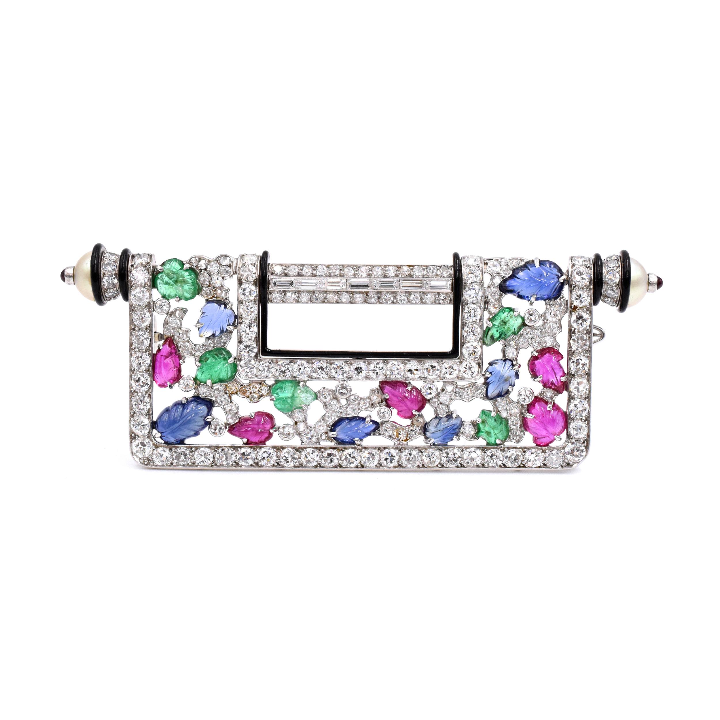 Gemstone and Diamond brooch. This brooch has diamonds, rubies, emerald, sapphire and black enamel, set in 18kt white gold and platinum. It has makers mark, french assay mark for Gold and Platinum, and Numbered: 1340. 
Measurements: 2.88 inches by 1