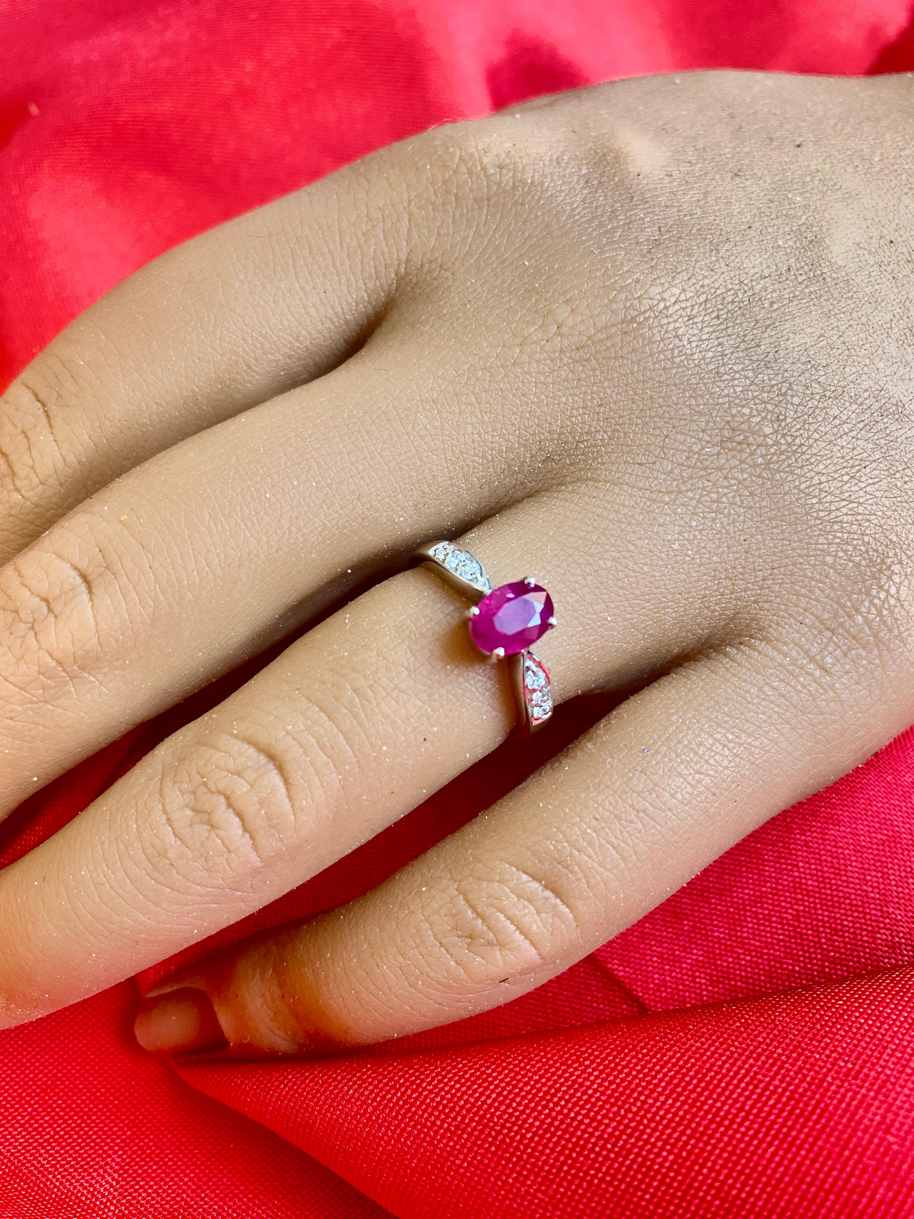 An oval Ruby ring that makes a STATEMENT! It is dainty, but it is a different one! This ruby ring can be stacked, but it can also be worn individually! The band is a tapered band with white diamonds that make the ring look different from up close