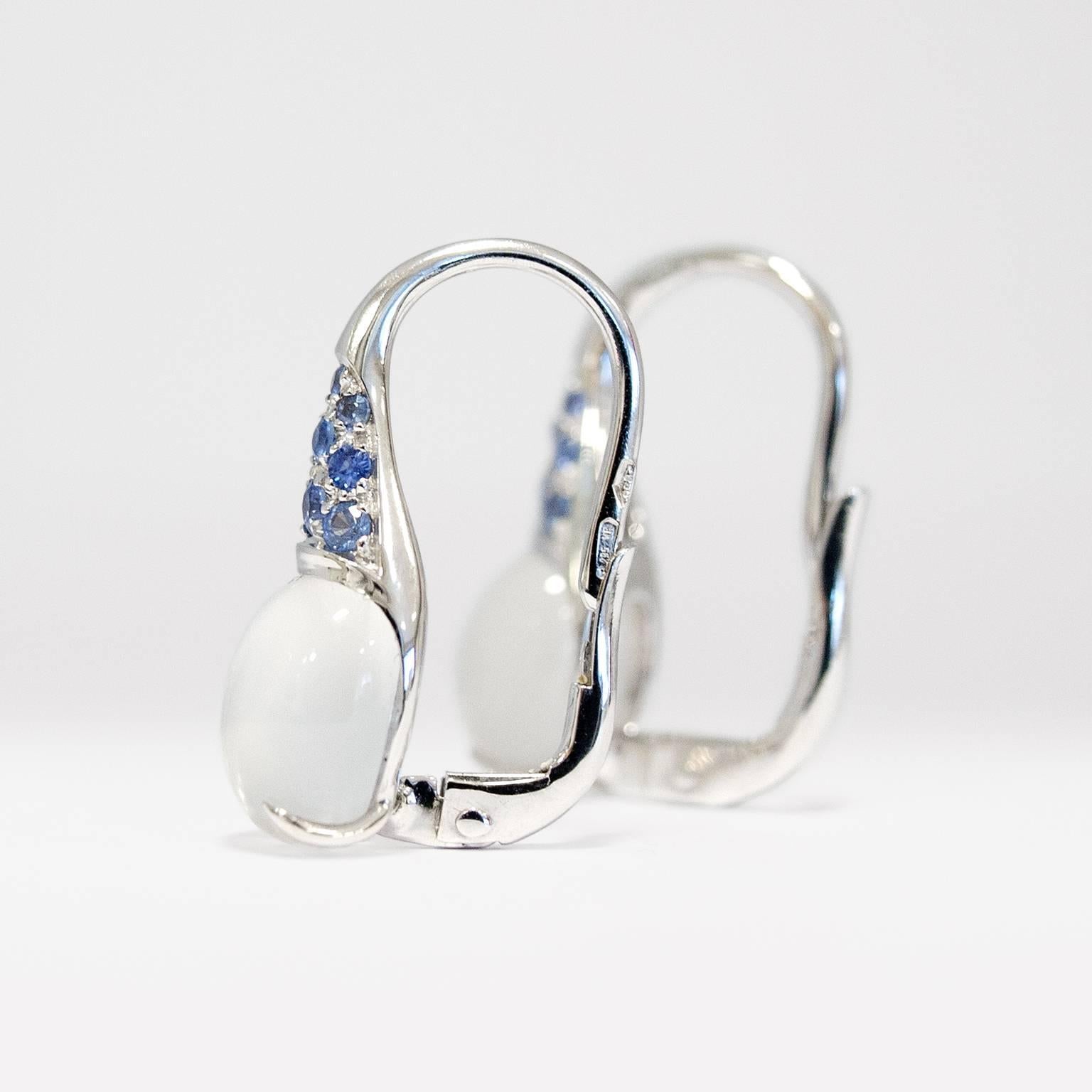 Italian Gemstone Blue Sapphire Moonstone 18 Karat White Gold Drop Hoop Earrings 

These earrings have two moonstone cabochon cut 8x10 mm and ct 0.36 light blue sapphires with lever spring clips in white gold. 
The cabochon are not standard cut, but
